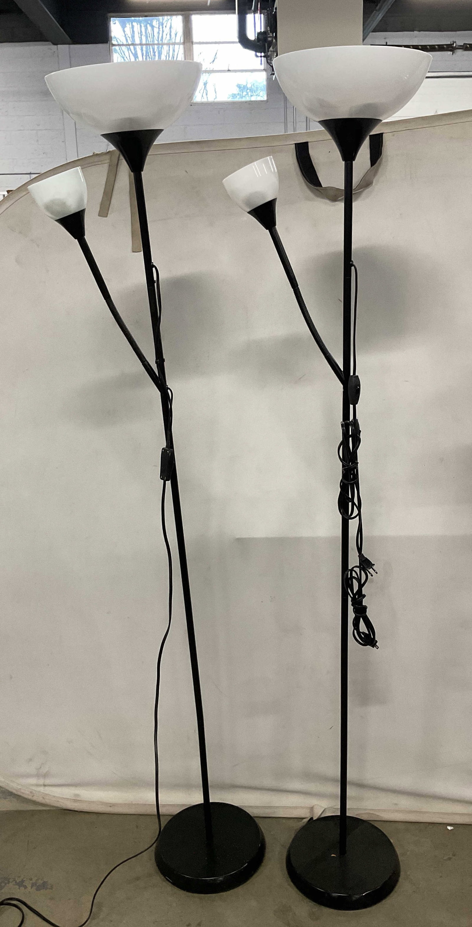 Pair IKEA Tagarp Black Uplighter Reading Lamps: Pair of signed IKEA Tagarp black metal uplighter/reading lamps. Measure approx. 14 x 68.75 inches. Not tested. Some scratching. IKEA lamp, Tagarp lamp, uplighter lamp, reading lamp, floor lamp, lighti