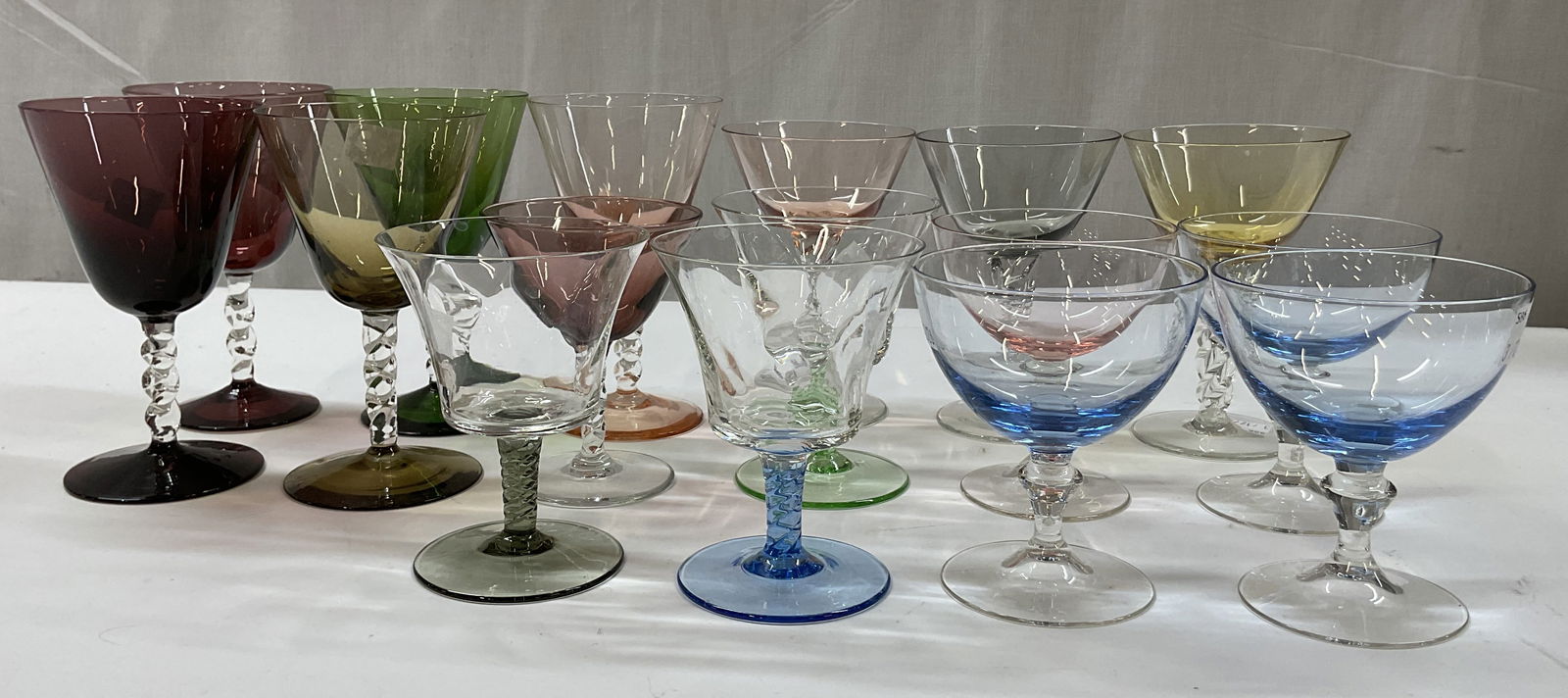 Grp Lot 16 Assorted Colorful Glass Stemware: Group lot of 16 assorted colorful glass stemware. Wine and champagne glasses. Twisted and stacked ball design stems. Blues, greens, pinks, etc. Size, shape, color, design vary. Largest measures ht app
