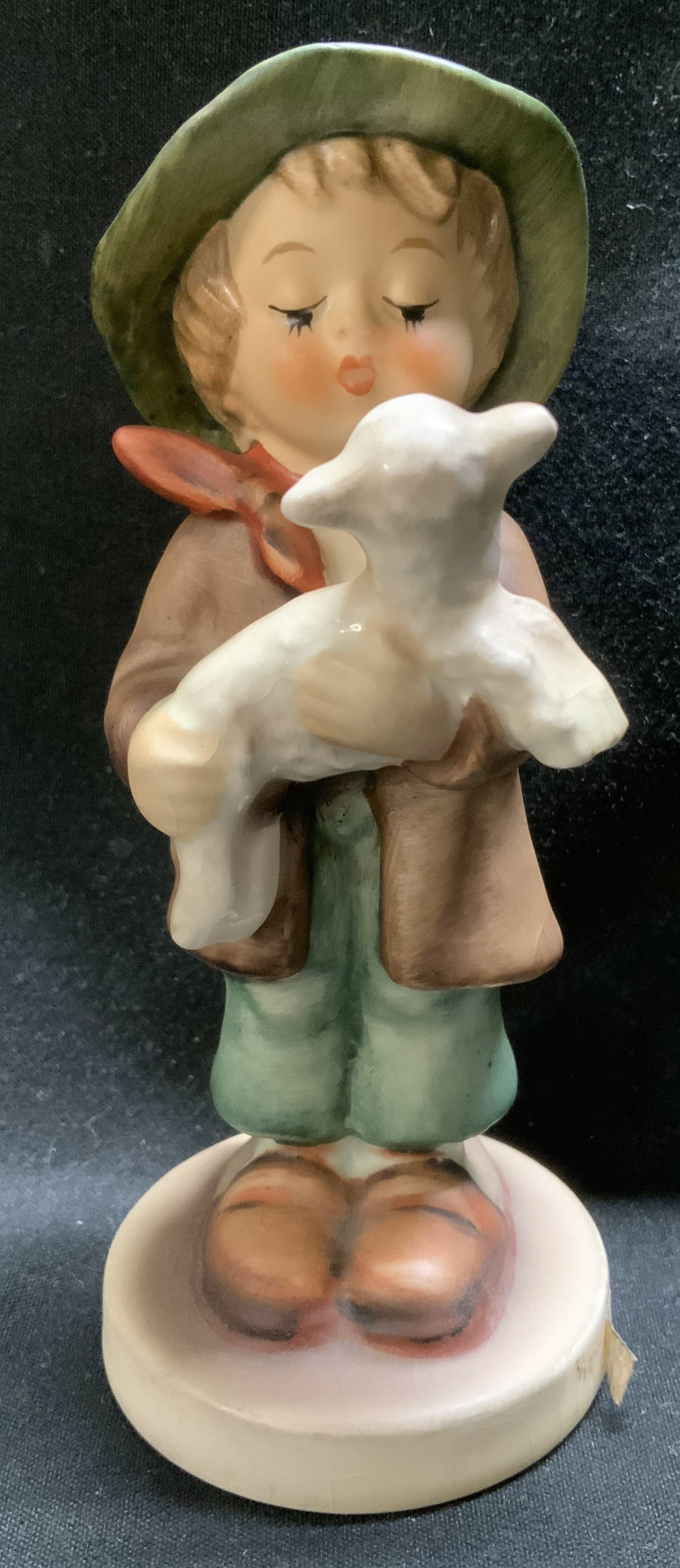 1962 Goebel Lost Sheep Ceramic Fig W GERMANY: 1962 Goebel ceramic figurine depicting a young boy holding a sheep. Round base. Signed & marked on underside. Reads, GOEBEL. W GERMANY 1962. Surface wear consistent to age, use & exposure. Measurement