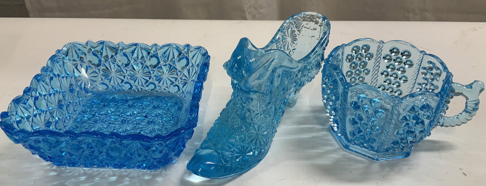 Lot 3 Vtg Blue Art Glass Dish, Teacup & Slipper: Lot includes, 1 square dish, 1 teacup & 1 slipper. Blue art glass. Textured feel & geometric accents. Vary in size & shape. No visible signature or markings. Surface wear consistent to age, use & expo