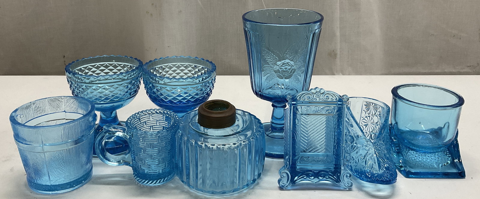 Lt 8 VTG Blue Art Glass: Lt 8 VTG Blue Art Glass. Includes baby shoe in a Fenton style, two matching goblets, a cup on a stand, a pail in a Bryce Brothers style, a wine glass with a rose pattern, a toothpick holder in a pictu