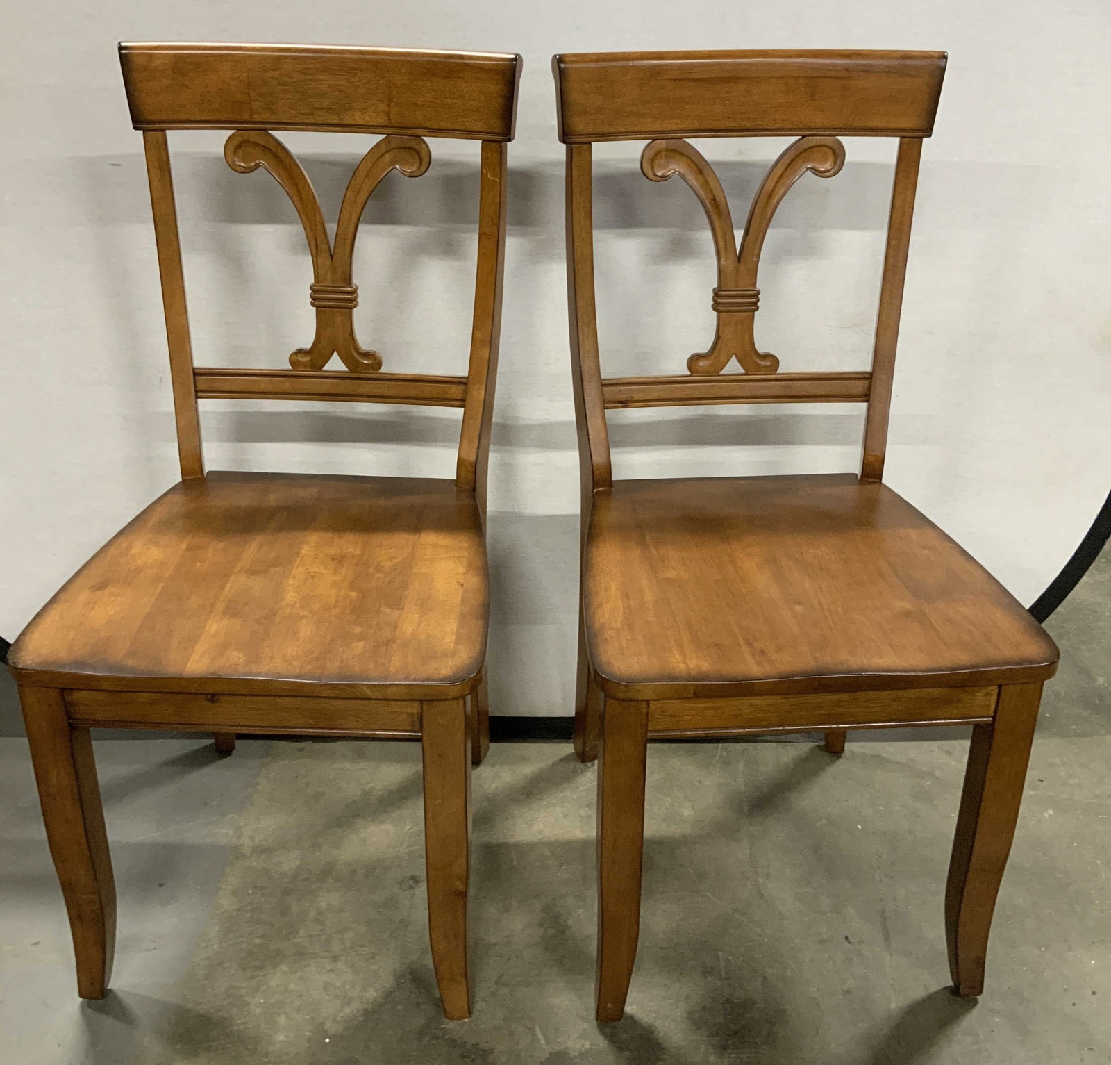 Pair Exclusive Pier 1 Imports Wooden Chairs: Lot includes, a pair of wooden chairs featuring a classic black splat design. Brown toned. Signed & marked on underside. Reads, EXCLUSIVELY FOR PIER 1 IMPORTS. Surface wear consistent to age, use & ex