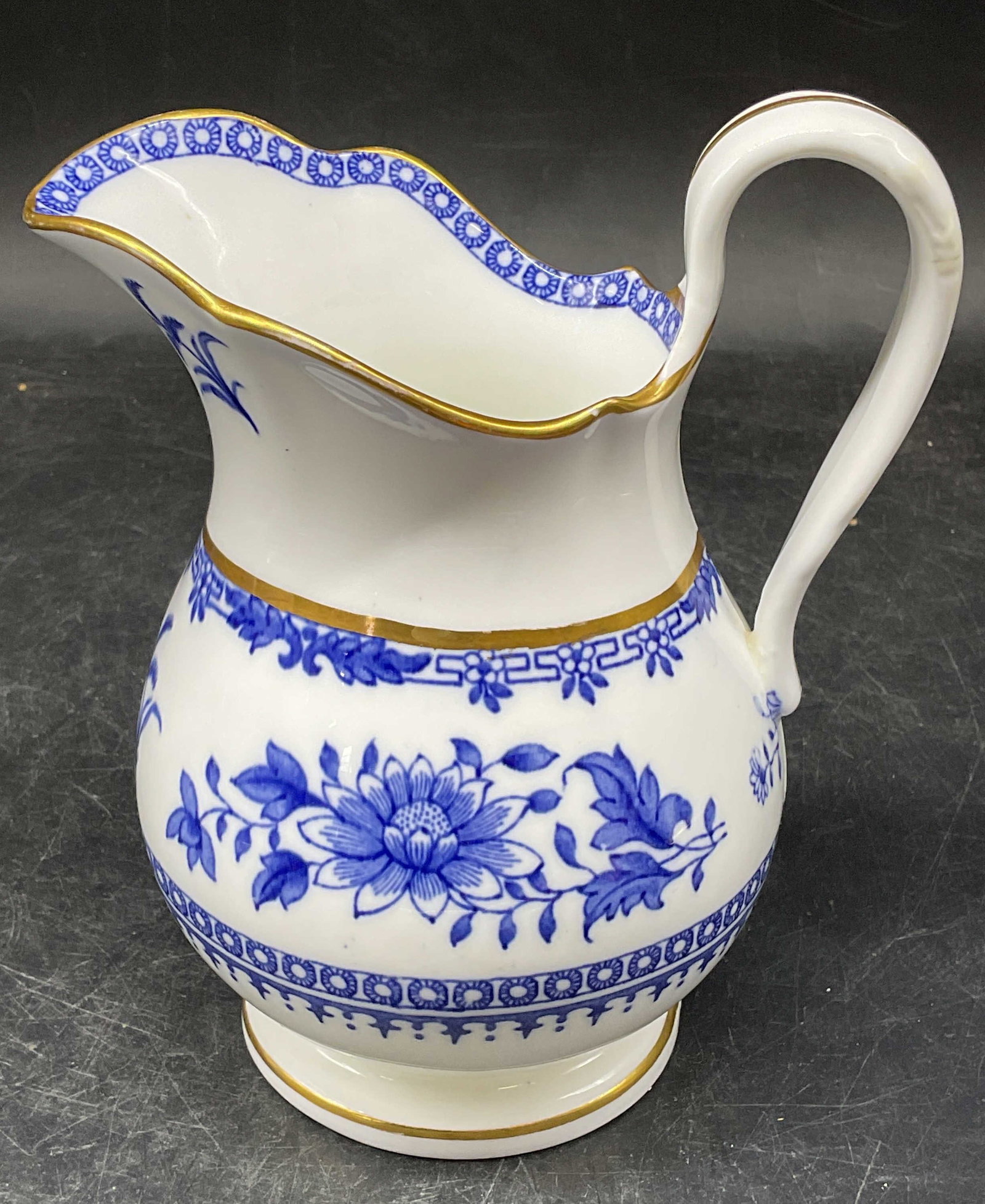 Vintage Minton Blue & White Creamer Pitcher: Vintage signed Minton ceramic blue and white creamer liter, floral design with gilt decoration. Measures approx. 5 x 4 x 6.25 inches. Some scratching and crazing. Minton creamer, Minton creamer, blue