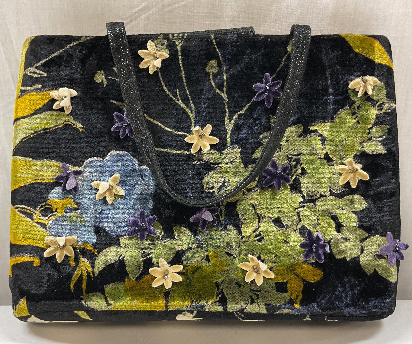 Rafe Black Velvet Floral Handbag: Rafe black velvet floral handbag. Tag reads Rafe New York. Velvet material. Floral motif pattern with applied flowers in varying colors. Button closure. Opens to zipper and compartments. Black