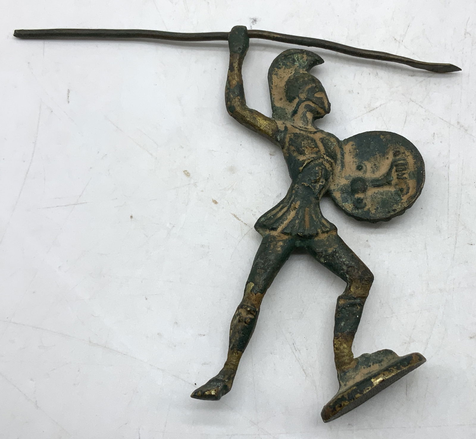 Vtg Cast Metal Spartan Warrior Figurine: Vintage cast metal figurine depicting a spartan warrior holding a raised spear & shield. Green toned. Surface wear consistent to age, use & exposure. Measurements: height to spear 5.6in x 4.2in x widt