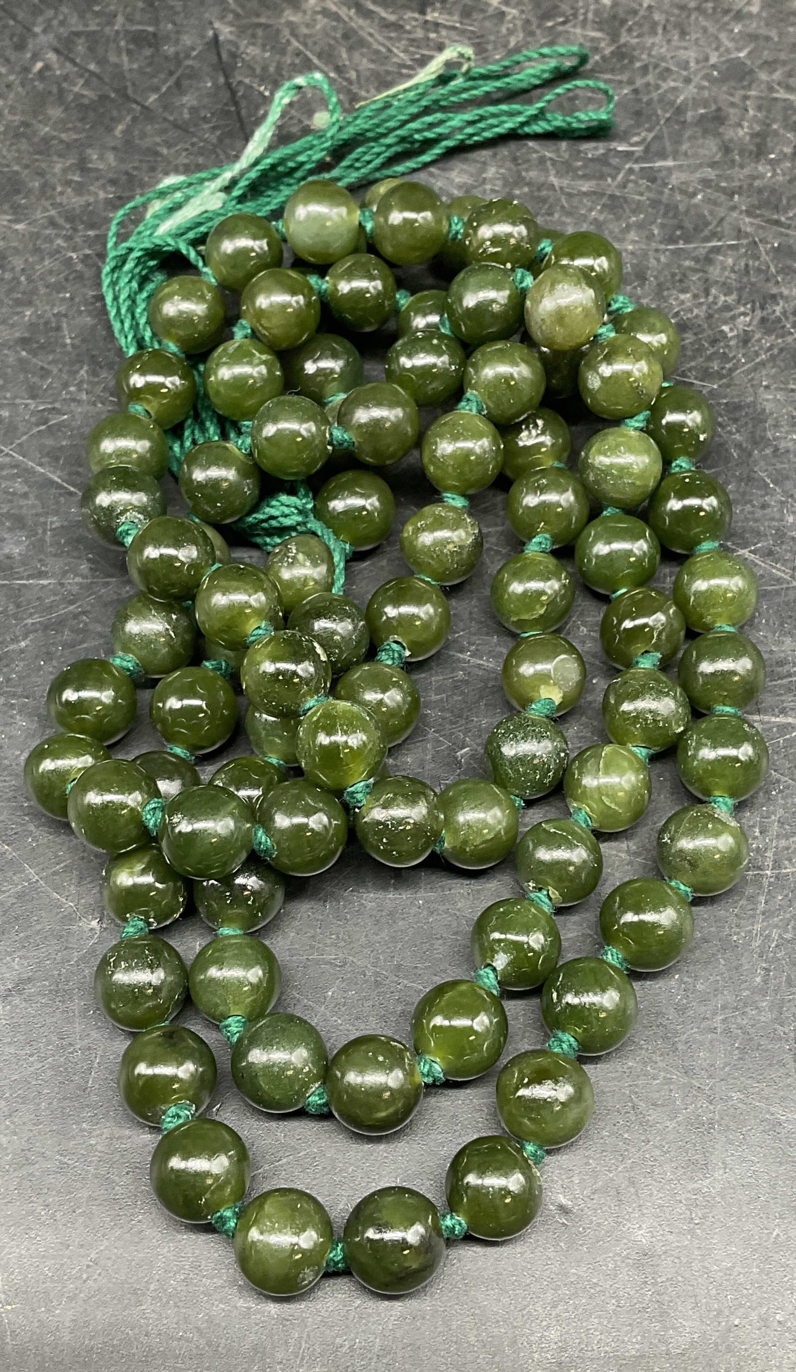 Vintage Nephrite Jade Beaded Necklace: Vintage nephrite jade beaded necklace on double knotted string. Drop length approx 16 inches. Some scratching. Jewelry, estate jewelry, costume jewelry, cocktail jewelry, fashion jewelry, accessories,
