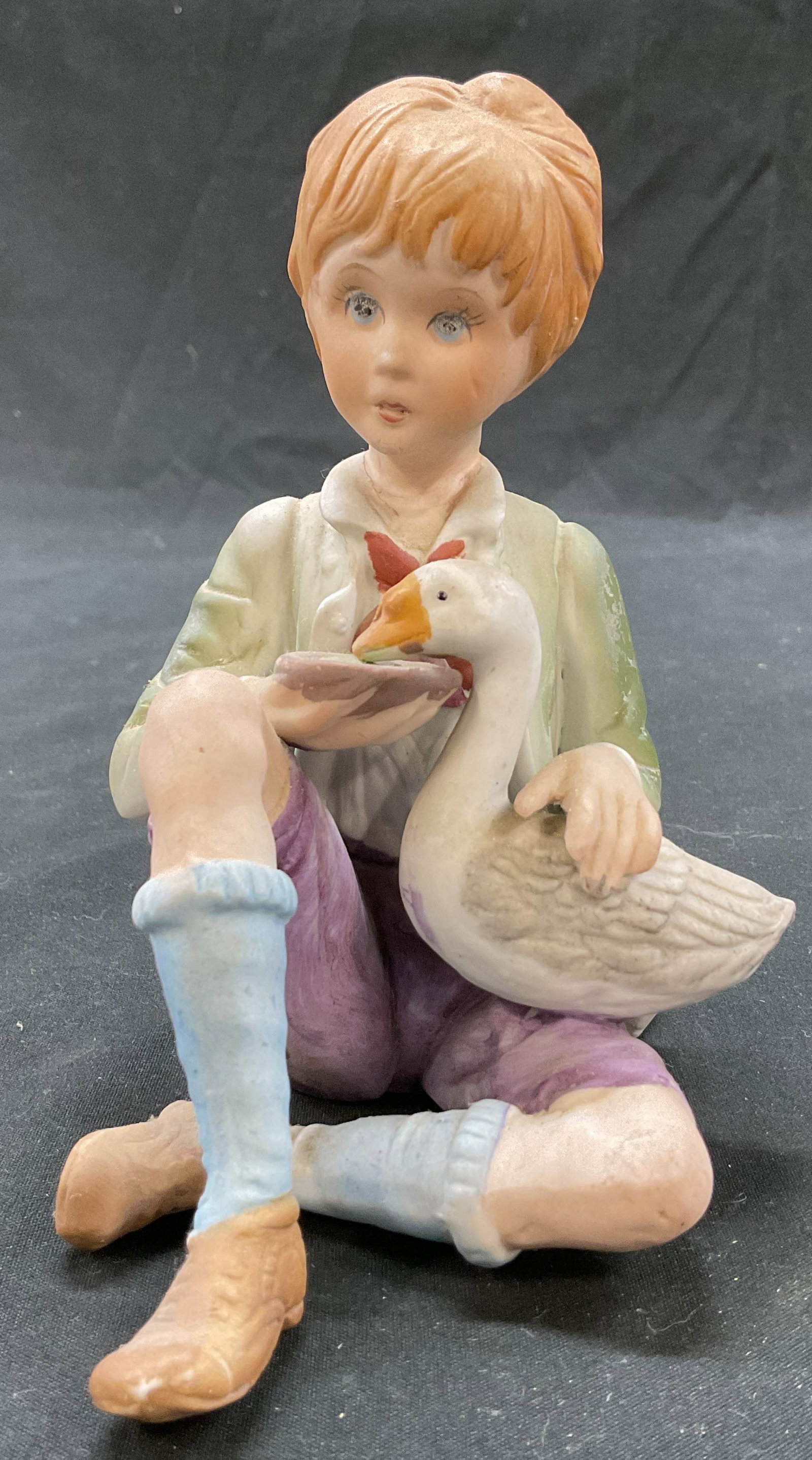 Ardalt Lenwile Porc Boy Feeding Goose Fig Korea: Ardalt Lenwile porcelain boy feeding goose figure. Marked on underside, reads Lenwile Ardalt Artware Korea. Boy is in a seated pose with a goose on his lap, feeding the goose. Hand painted in varying