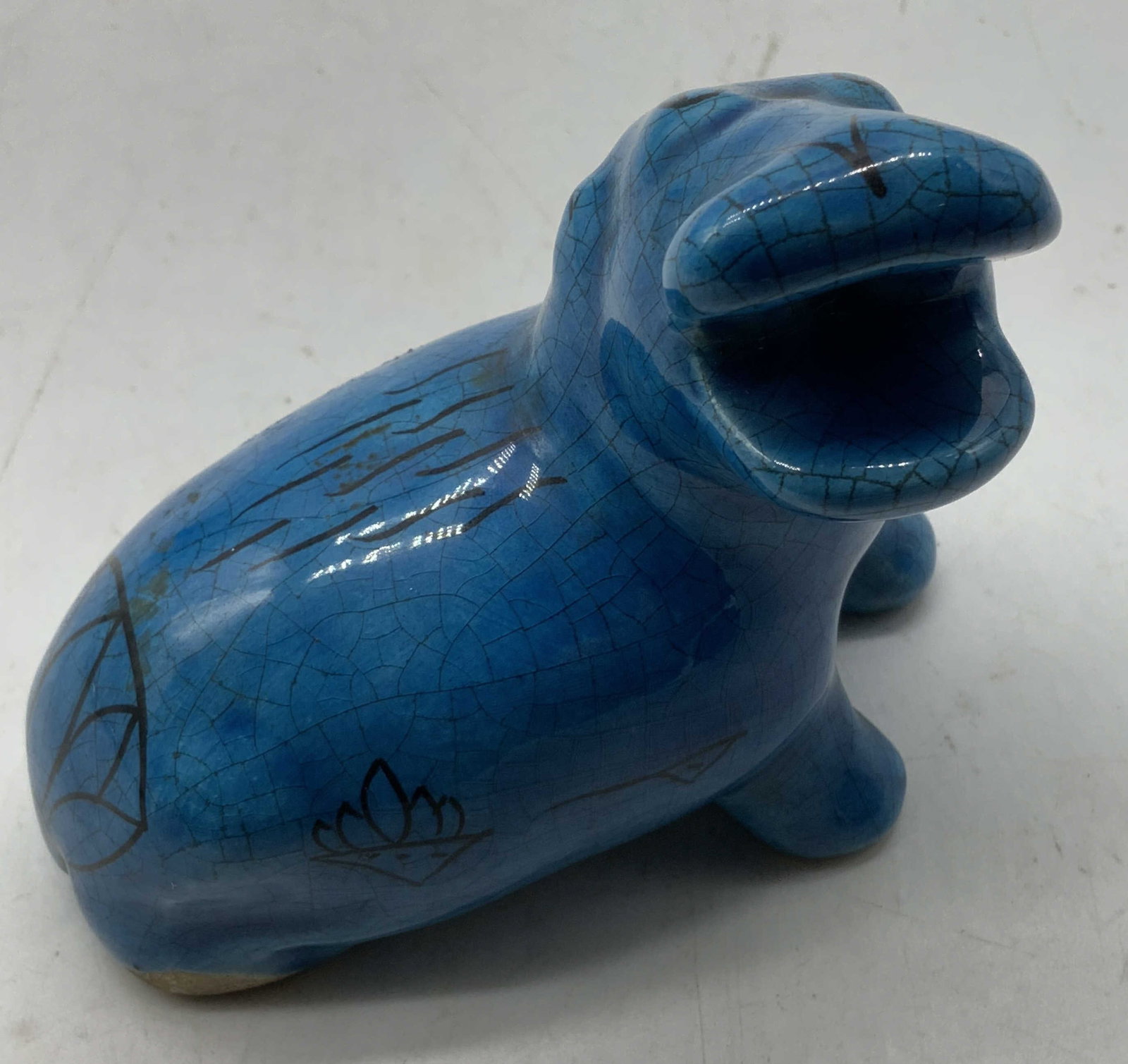 Metropolitan Museum Hippopotamus Pottery Fig: Replica of the famous William the Hippopotamus Egyptian faience statuette from the Metropolitan Museum of Art. Blue finish with black accents on body. Sold as is. Signed & marked on underside. Reads,