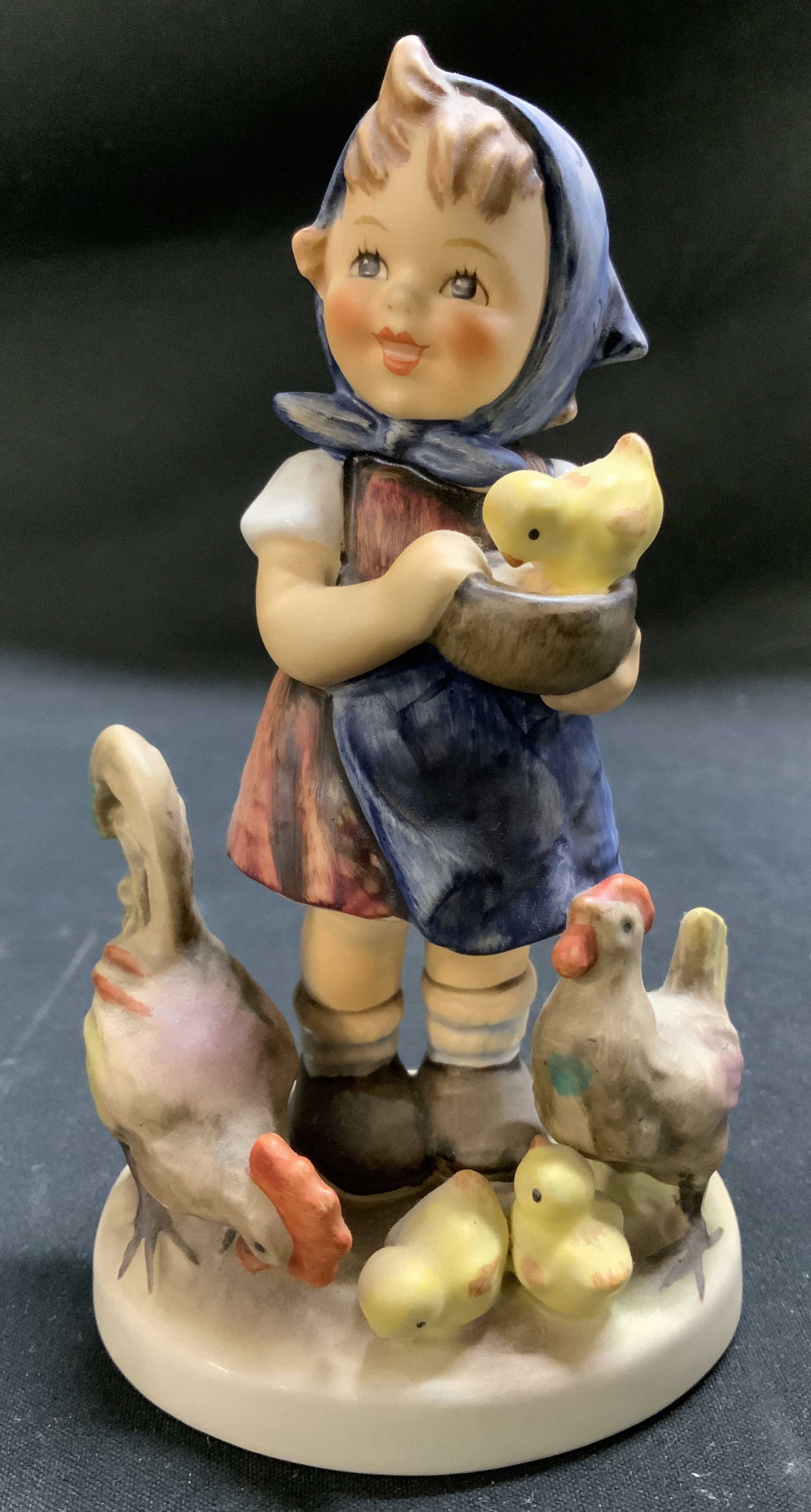 1948 Goebel Feeding Time Ceramic Fig W GERMANY: Vintage Goebel Feeding Time Im Huhnerhof ceramic figurine depicting a young girl feeding chicks & chickens. Signed & marked on underside. Reads, GOEBEL W.GERMANY. 1948. Surface wear consistent to age,