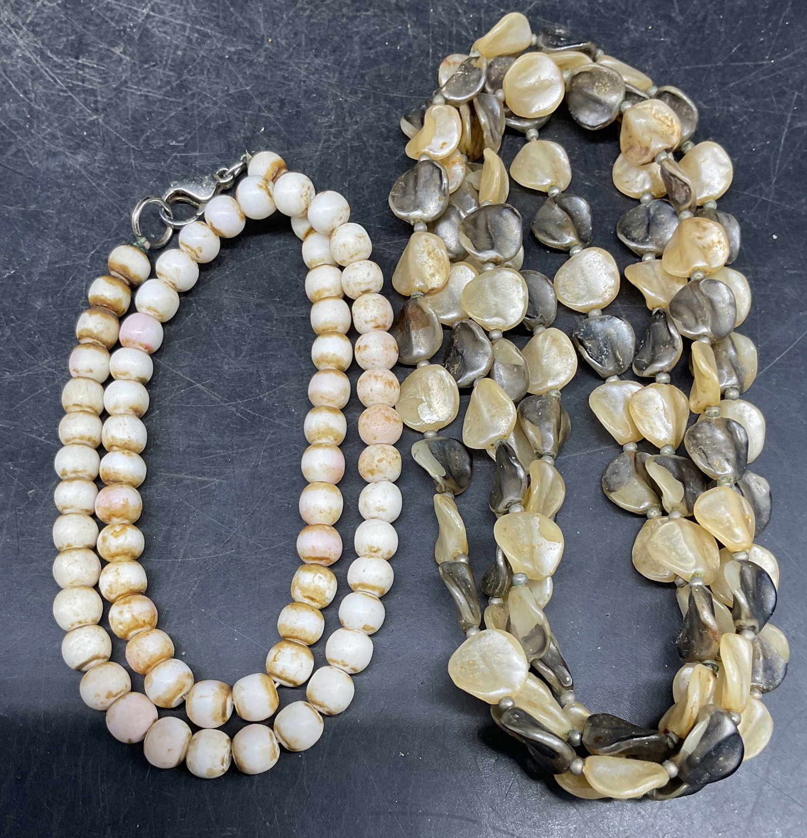 Lot 2 Shell & Faux MOP Beaded Necklaces: Lot of 2 necklaces. Vintage white shell beaded necklace and vintage faux mother of pearl beaded necklace. Longer drop length measures approx. 24 inches. Some scratching. Jewelry, estate jewelry, costu
