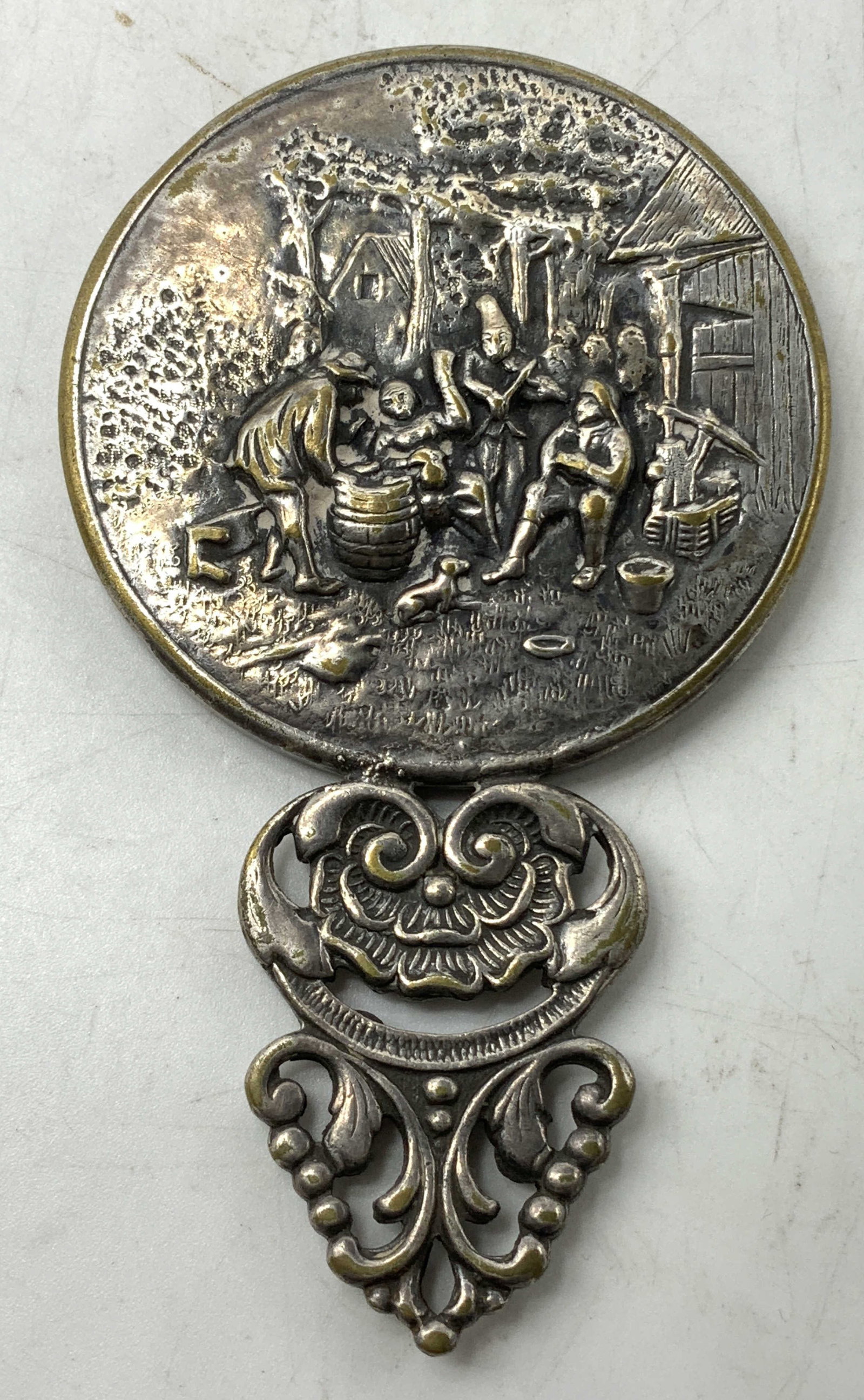 Vtg Spritzer & Fuhrmann Silver Plated Hand Mirror: Vtg Spritzer & Fuhrmann silver plated hand mirror featuring a detailed repousse scene. Group of people gathered outdoors. Ornate handle. Signed & marked. Reads, Spritzer & Fuhrmann 297. Surface wear c