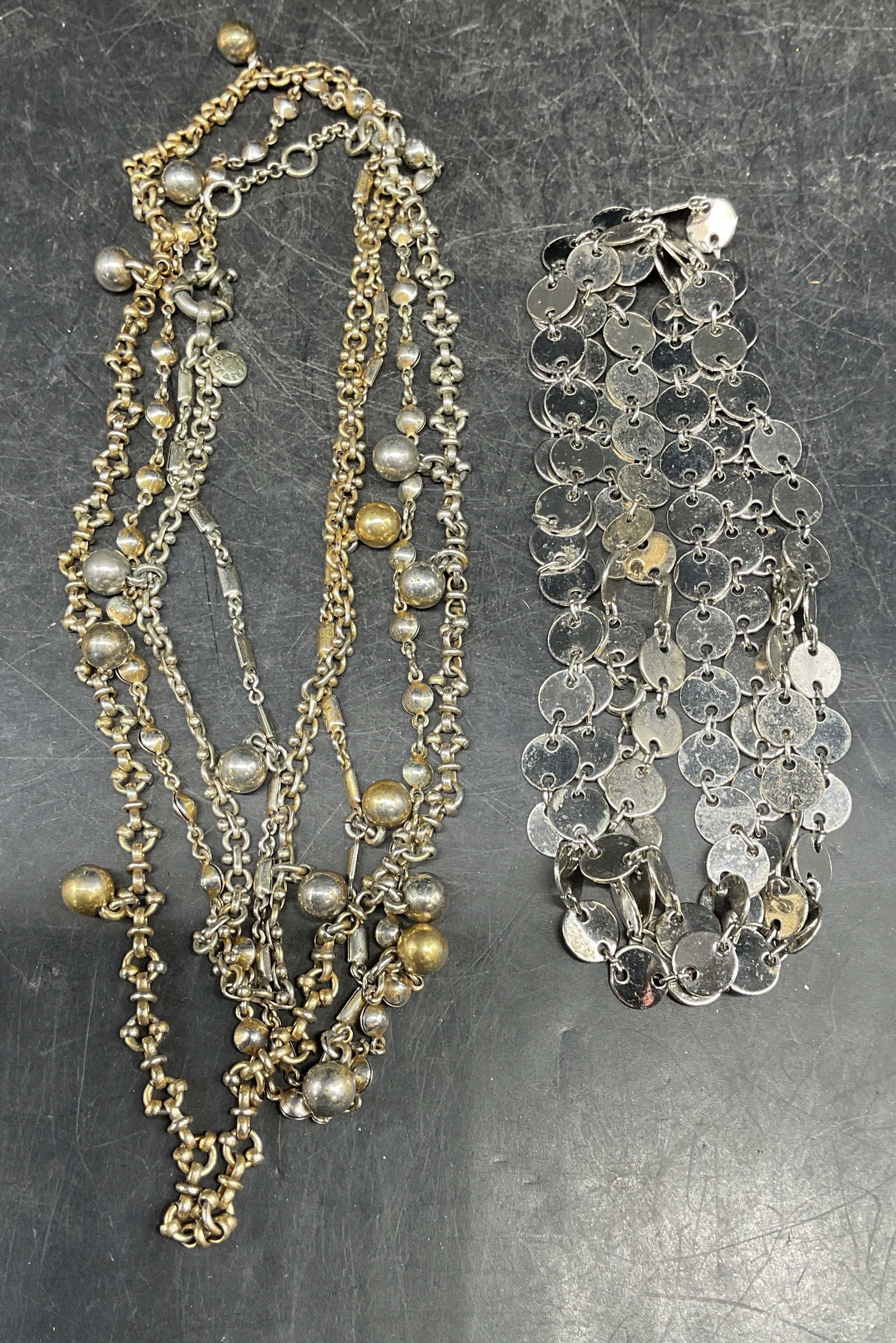 Lot 2 J Crew Silver & Gold Tone Necklace +: Lot of 2 necklaces. Signed J Crew silver and gold tone double chain necklace. Silver tone disc beaded necklace. Longer necklace drop length measures approx. 24 inches. Some scratching. Jewelry, estate
