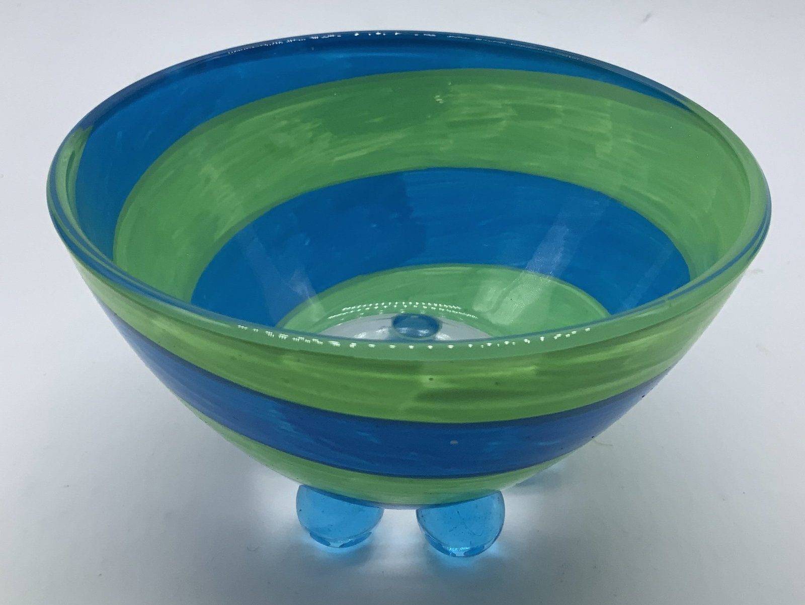 Detroit Glass Company Striped Bowl FRANCE: Detroit glass company bowl features a green & blue striped pattern. Supported by 4 glass orb style feet. Signed & marked on underside. Reads, DETROIT GLASS COMPANY. ARC FRANCE. Surface wear