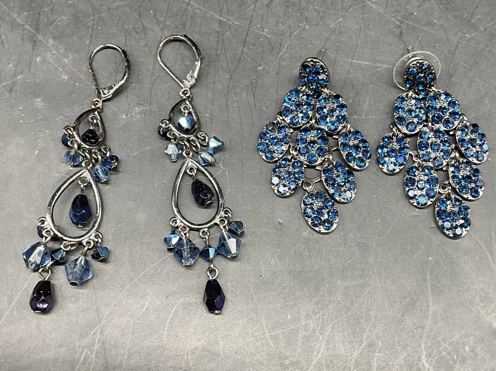 Lot 2 Blue Crystal Chandelier Earrings: Lot of 2 silver tone blue crystal chandelier earrings. Longer measures approx. 2.5 inches. Some scratching. Jewelry, estate jewelry, costume jewelry, cocktail jewelry, fashion jewelry, accessories, fa