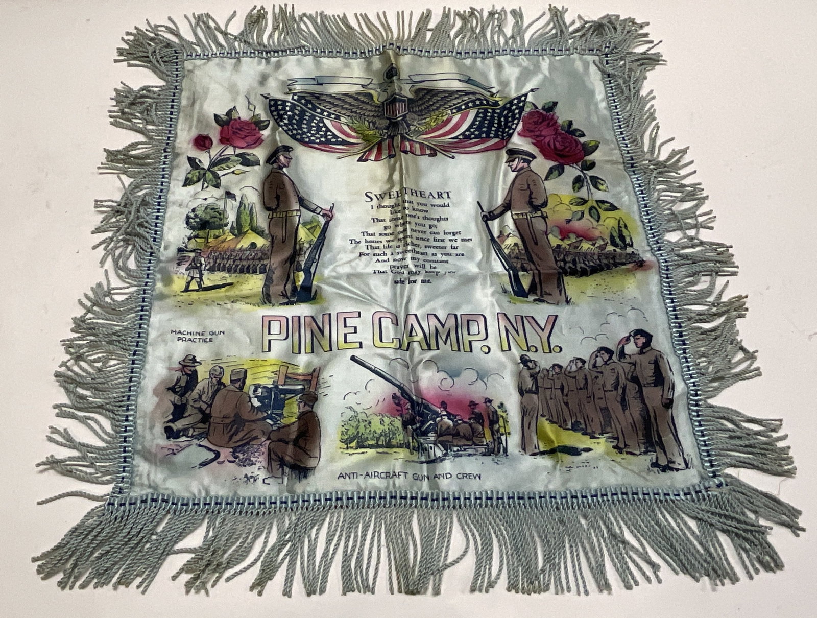 VTG WWII Sweetheart Pillow Cover: Vintage WWII Sweetheart Pillow Cover. Fringe on edges. Depicts soldiers and a poem in the middle. Pine Camp, Ny is written. Measures app 18in L. Some wear consistent with age. Vintage, WWII, World War