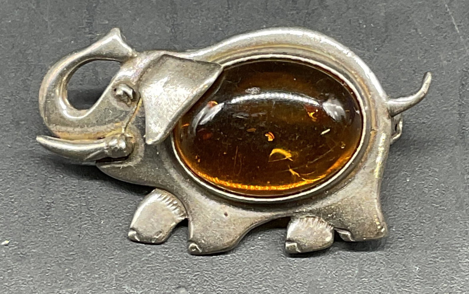 Vintage Silver Tone Amber Elephant Brooch: Vintage silver tone amber cabochon elephant brooch. Measures approx. 1.25 x .75 inches. Some scratching. Jewelry, estate jewelry, costume jewelry, cocktail jewelry, fashion jewelry, accessories, fashi