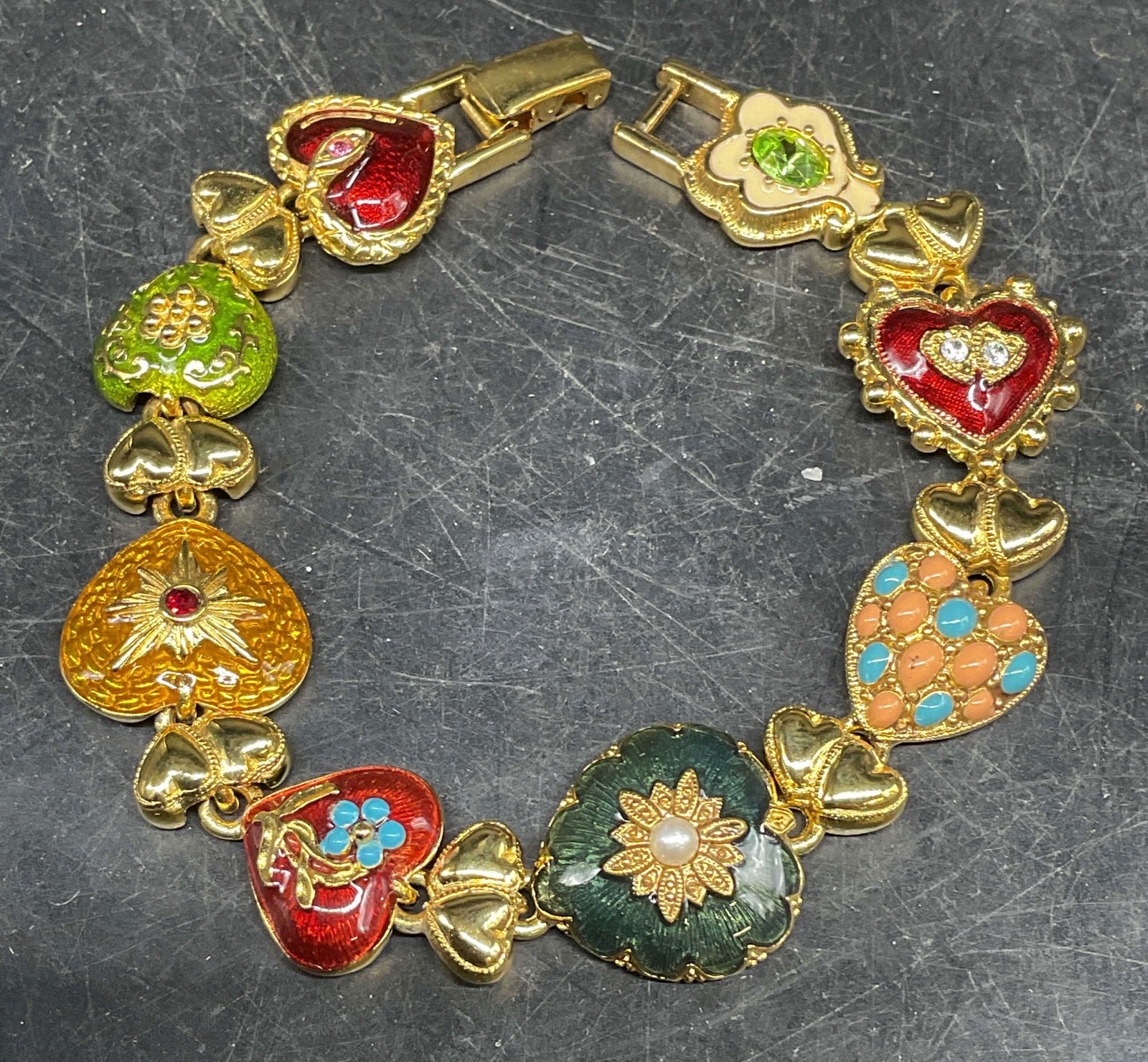 Joan Rivers Enamel Crystal Heart Bracelet: Signed Joan Rivers gold tone multicolor enamel and crystal heart motif bracelet. Measures approx. 7.5 inches long. Some scratching. Jewelry, estate jewelry, costume jewelry, cocktail jewelry, fashion