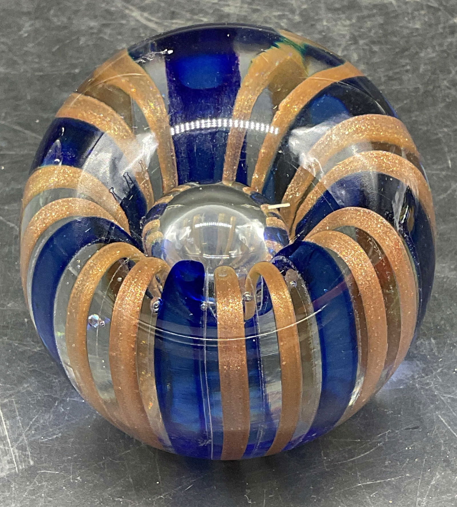 Signed Gold & Blue Striped Art Glass Paperweight: Signed hand blown art glass paperweight. Gold fleck and cobalt blue stripe with controlled bubble. Signed illegibly. Measures approx. 3 x 3.25 inches. Some scratching. Art glass paperweight, collectib