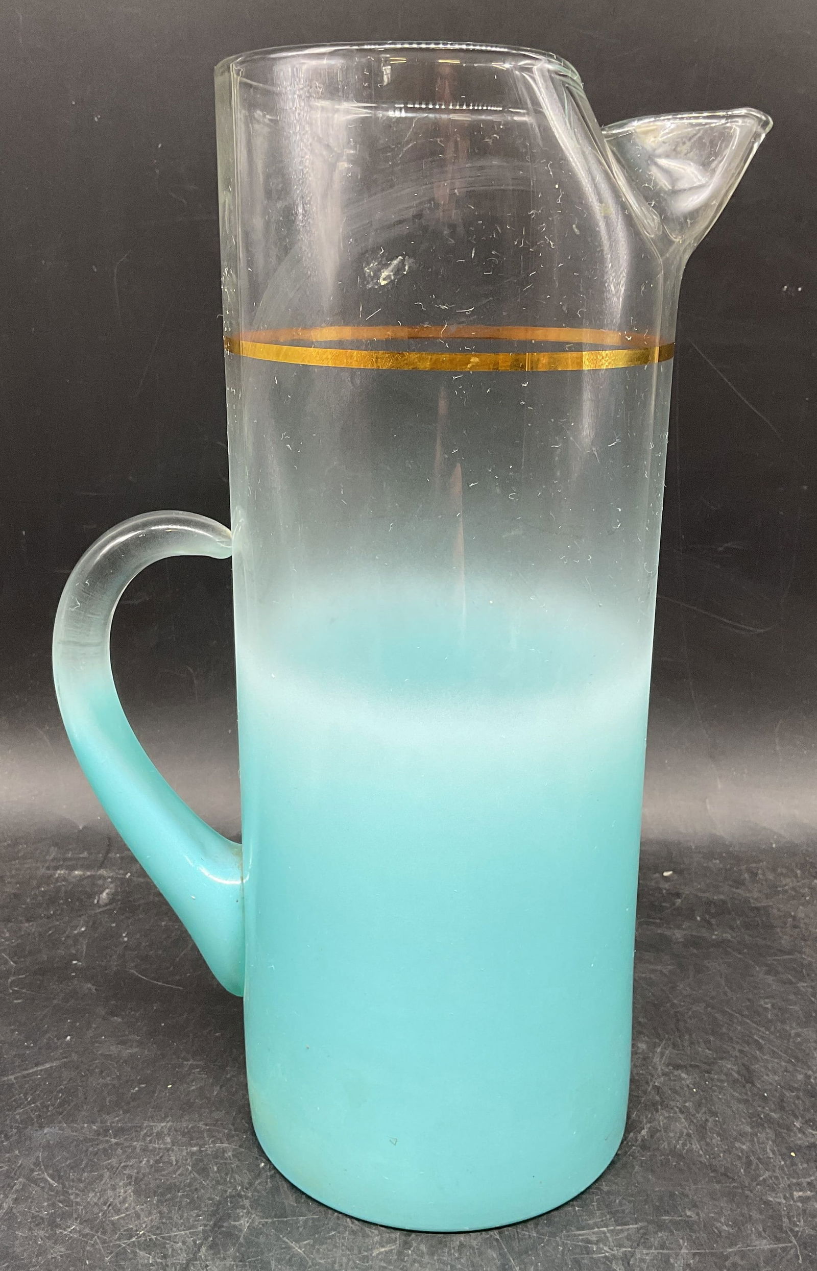 1950s Blendo Blue Frosted Glass Pitcher: Vintage circa 1950s glass pitcher in clear to frosted blue with gilt band. Blendo, no signature or marks observed. Measures approx. 8 x 4.25 x 11.25 inches. Wear including scratching. Blendo pitcher,