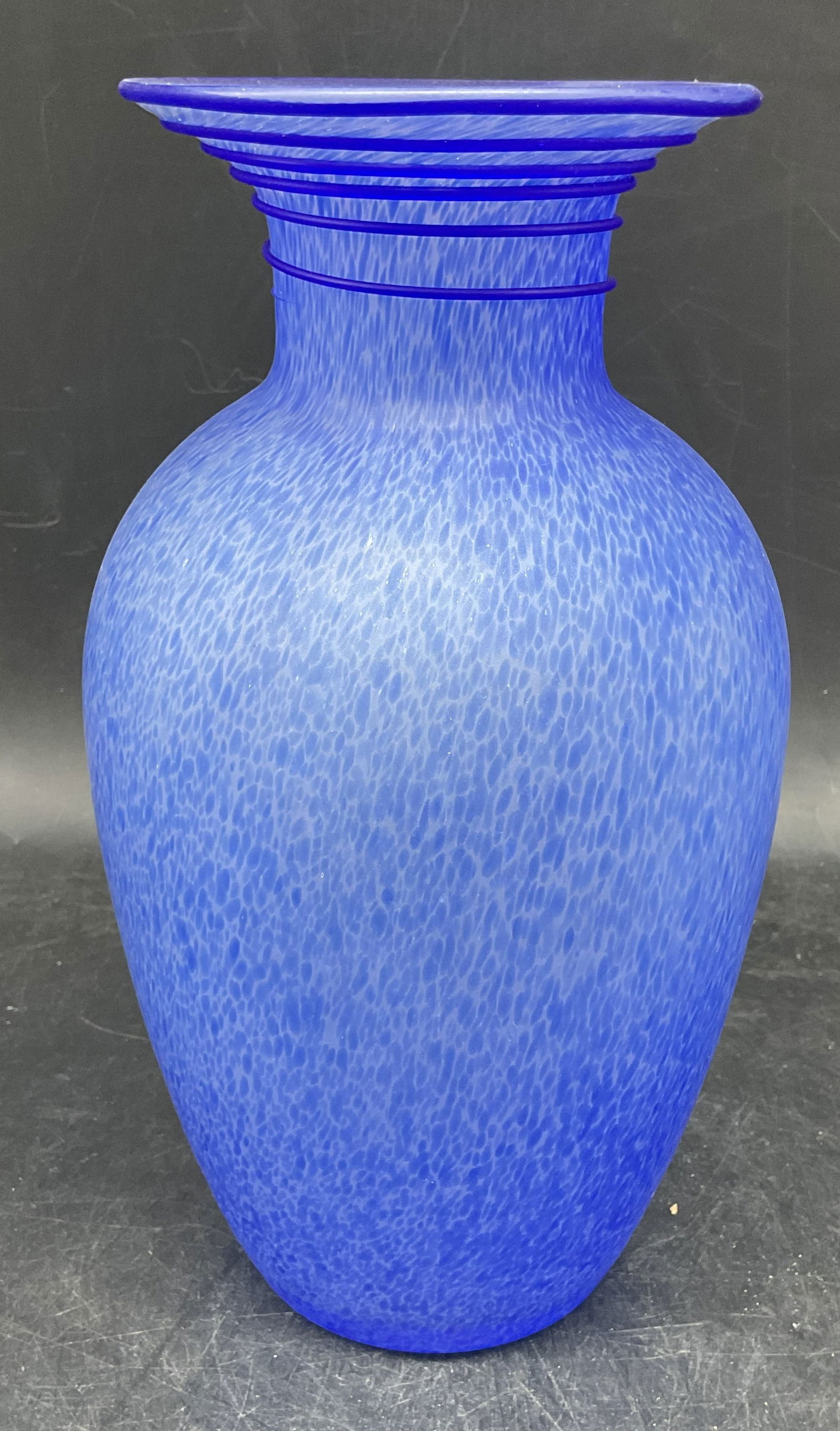 Mottled Cobalt Blue Satin Art Glass Vase: Mottled satin art glass vase in cobalt blue with applied blue swirl on rim. Curved shape with fluted rim. Measures approx. 5 x 9.75 inches. Some scratching. Art glass vase, collectibles, decorative ar
