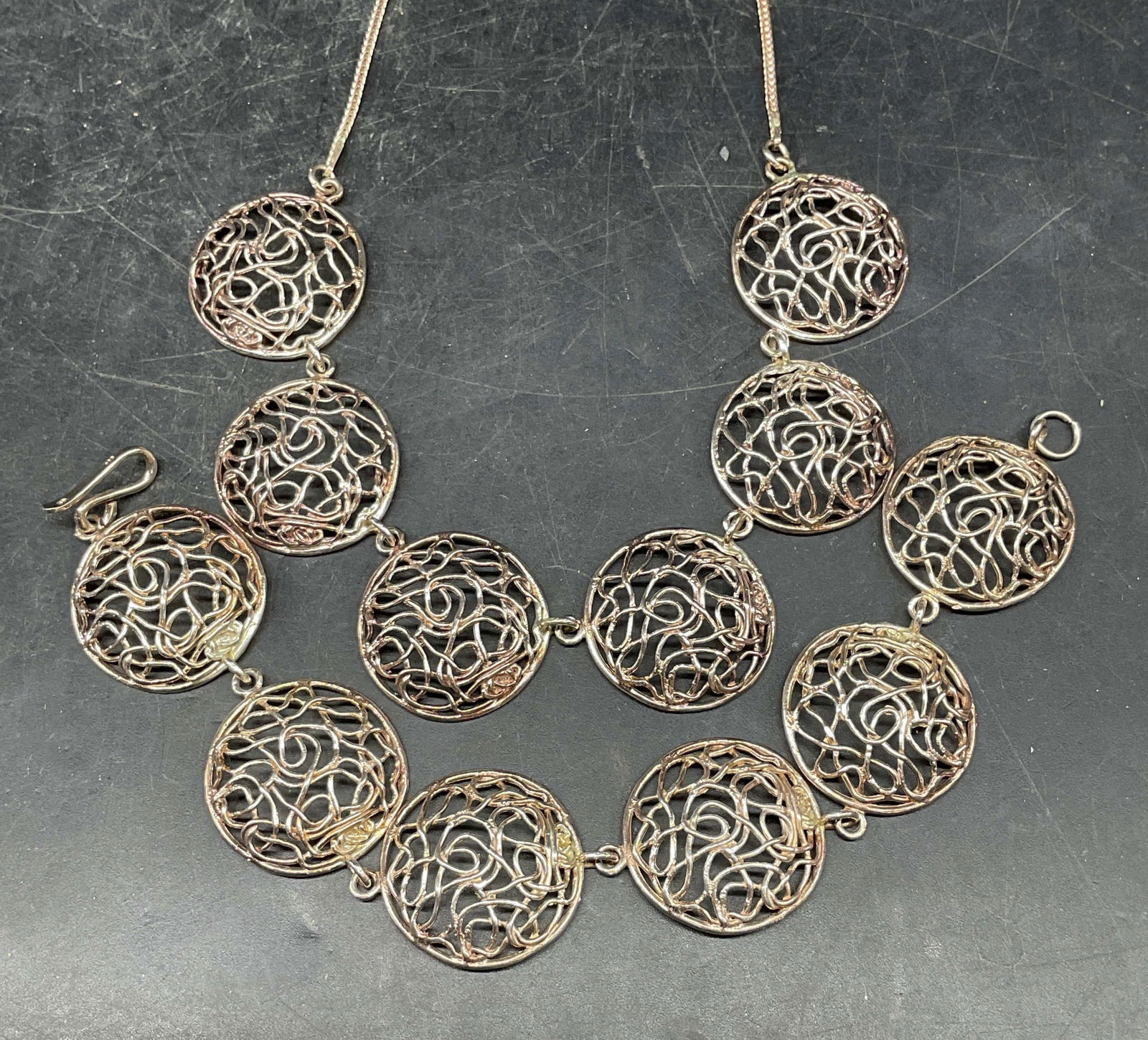 2 Sterling Silver Medallion Necklace & Bracelet: Lot of 2 vintage matching jewelry pieces. Sterling silver filigree medallion necklace and bracelet. Necklace drop length approx. 7.5 inches. Bracelet measures approx. 7 inches long. Total weight 30.2