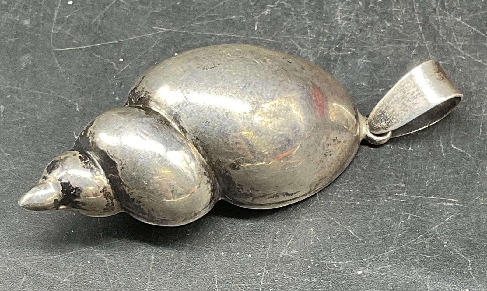 Vintage Sterling Silver Conch Shell Pendant: Vintage sterling silver conch shell motif pendant. Measures approx. 2 inches long. Total weight 15.8 grams. Marked sterling. Some scratching. Jewelry, estate jewelry, fine jewelry, cocktail jewelry, f