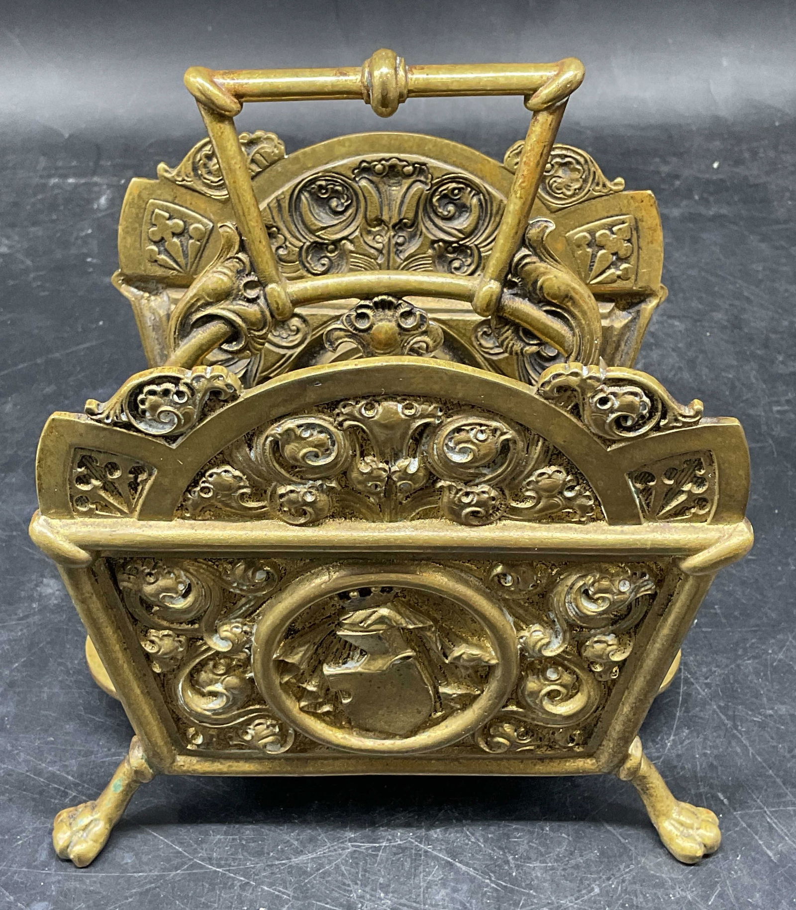 Antique Ornate Brass Letter Holder Rack: Antique brass letter holder rack. Ornate scroll design with claw feet and handle. Measures approx. 5.75 x 4.5 x 6 inches. Wear including patina, scratching, warping. Antique letter holder, antique