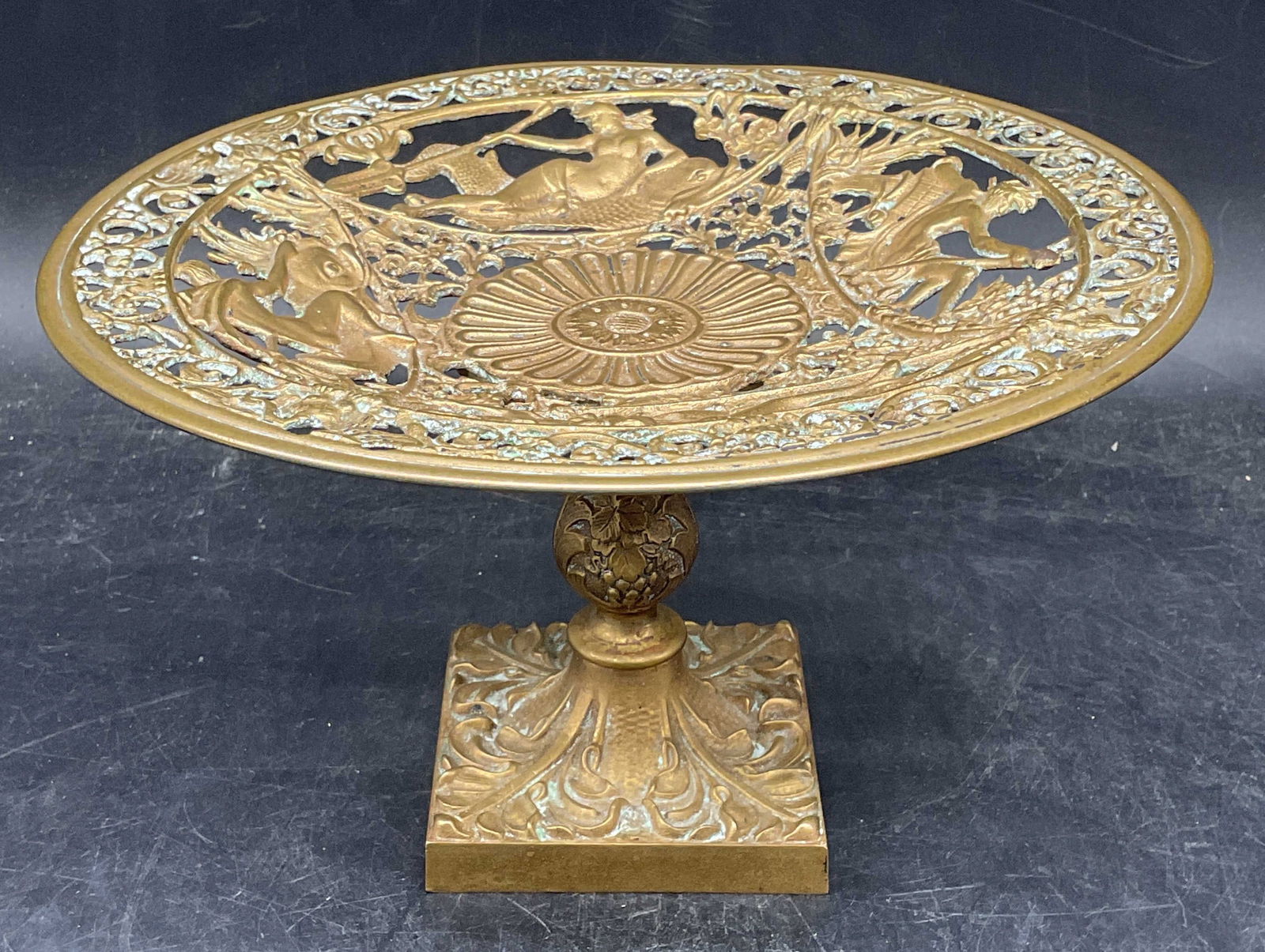 Antique Brass Filigree Classical Tazza: Antique brass filigree tazza with classical style ornate scroll, figural, and dolphin design. Pedestal base. Measures approx. 8.5 x 5 inches. Wear including scratching and patina. Antiques,