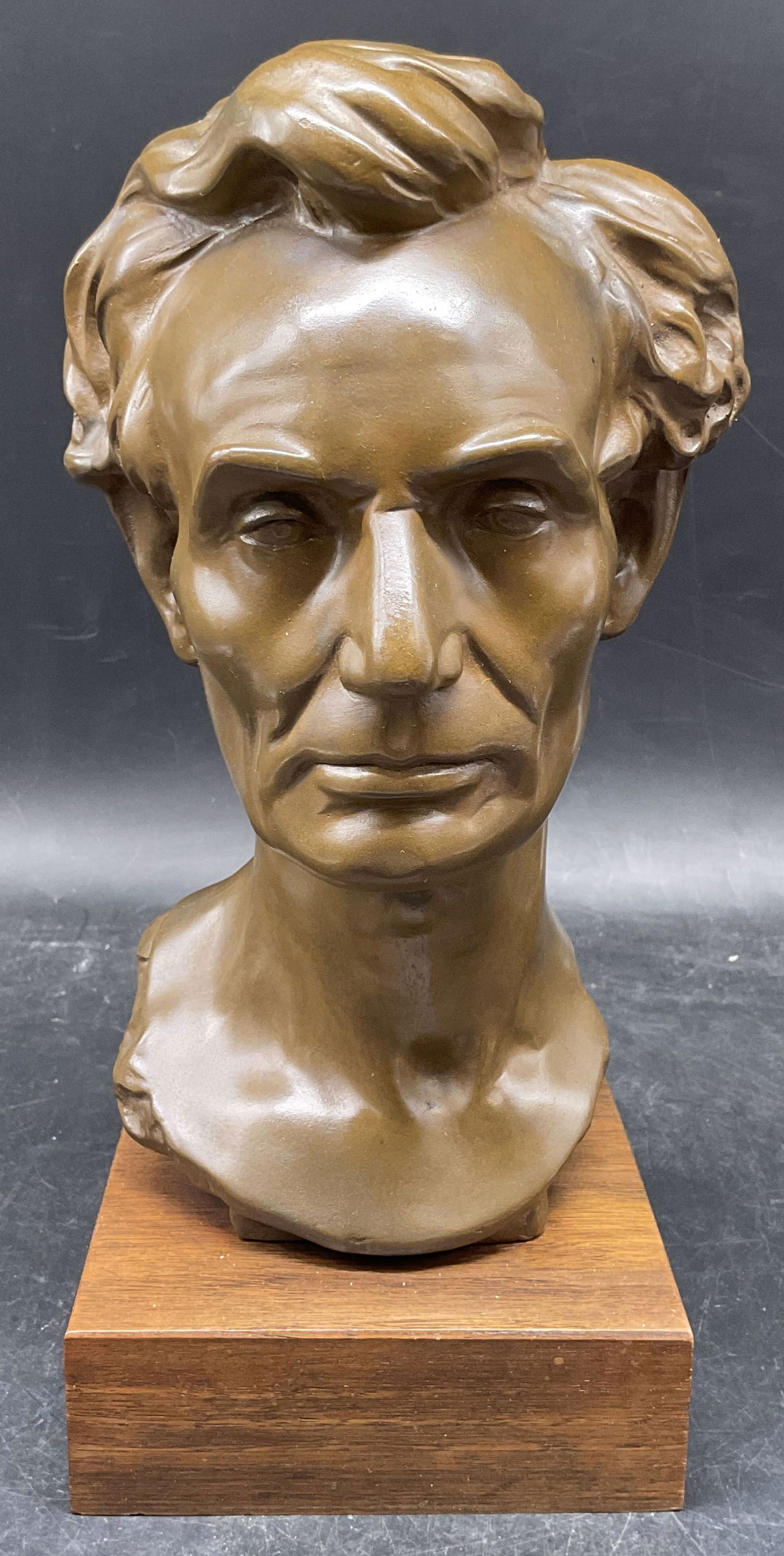Alva Studios Abraham Lincoln Volk Bust Sculpture: Vintage Alva Studios replica bust of Abraham Lincoln. Original modeled by Leonard Volk. Bronze patina. Wood base. Signed. Measures approx. 5 x 5 x 11.5 inches. Some wear including scratching.