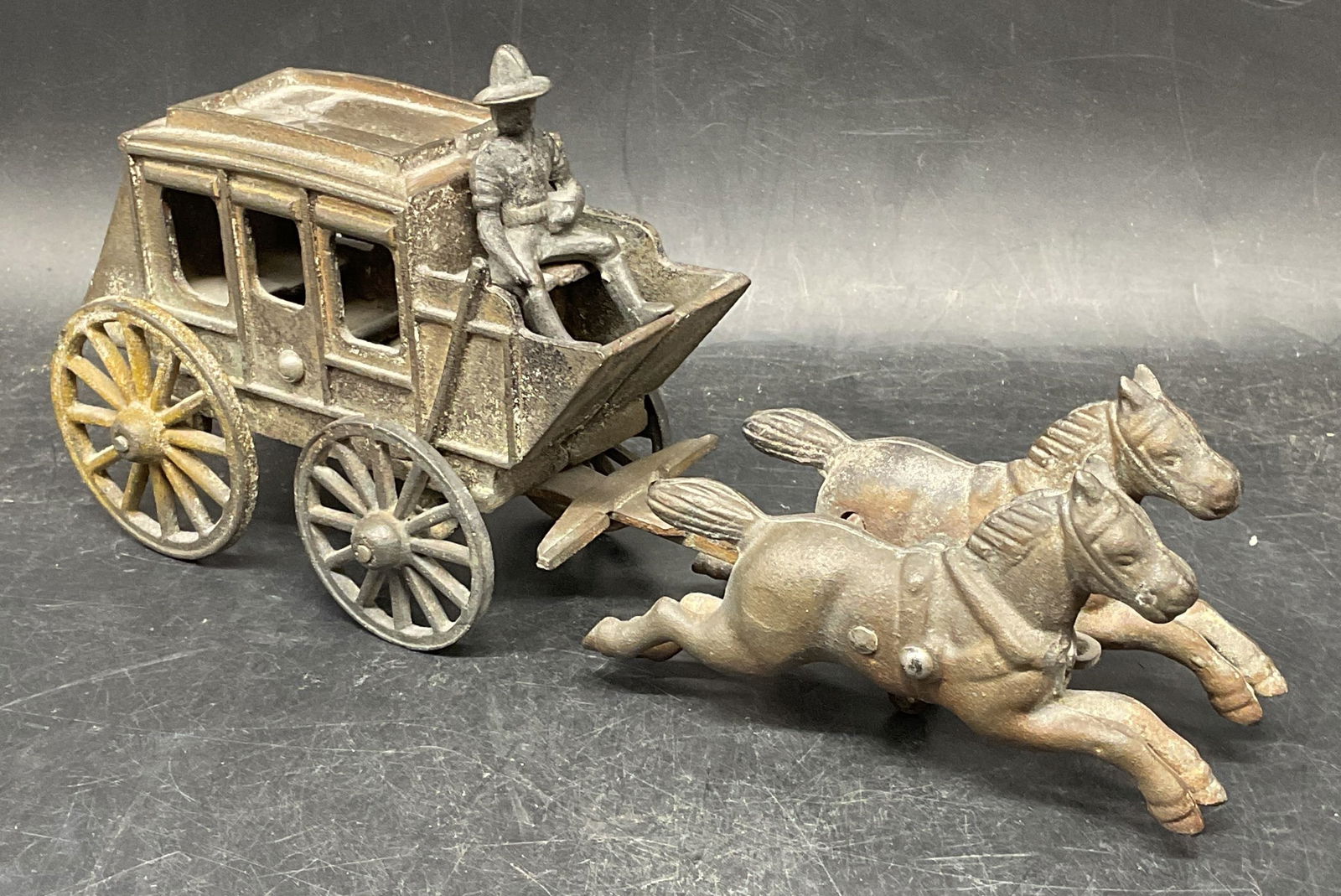 Antique Iron Horse Drawn Carriage Toy: Antique iron horse drawn carriage with rider toy. Measures approx. 11 x 3 x 5 inches. Wear including patina, scratching. Property of Manhattan, New York collectors estate. Antiques, collectibles, anti