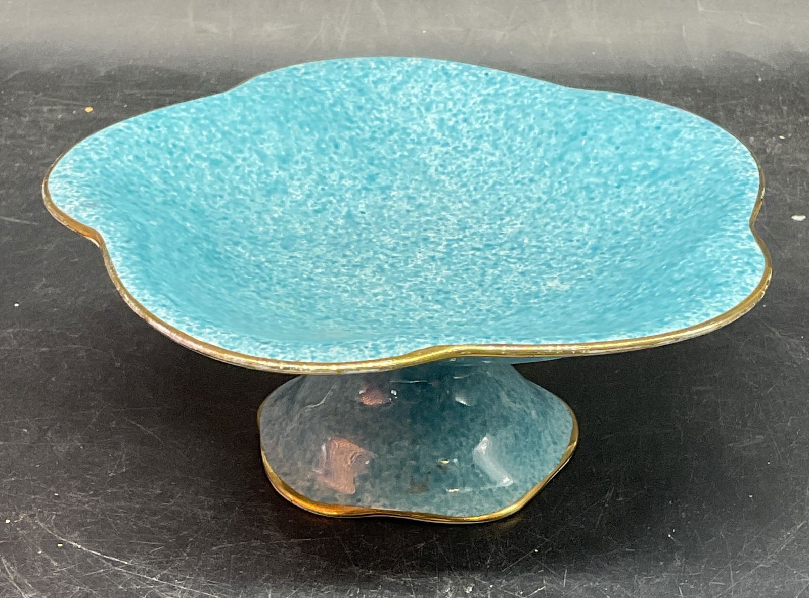 Vtg Royal Winton Blue Speckled Tazza, England: Vintage Royal Winton Grimwades ceramic pedestal tazza. Hand painted speckled blue with gilt rim. Scalloped rim. Made in England. Measures approx. 6.5 x 2.75 inches. Some scratching. Royal Winton tazza