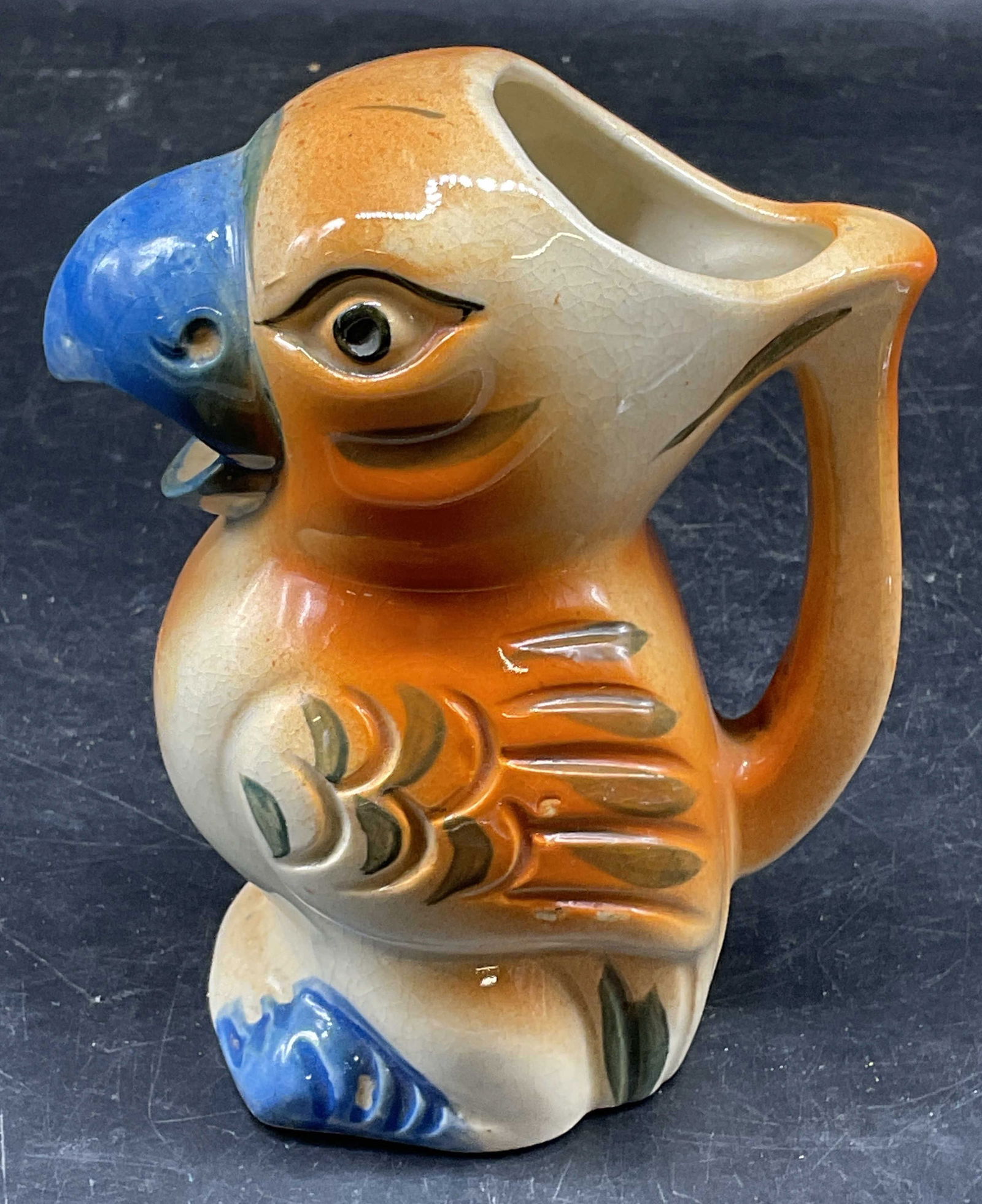 Vintage Ceramic Parrot Bird Creamer, Japan: Vintage ceramic parrot build motif creamer. Hand pasted orange and blue. Made in Japan. Measures approx. 4 x 2.5 x 4.5 inches. Wear including scratching and crazing. Parrot creamer, bird creamer, coll