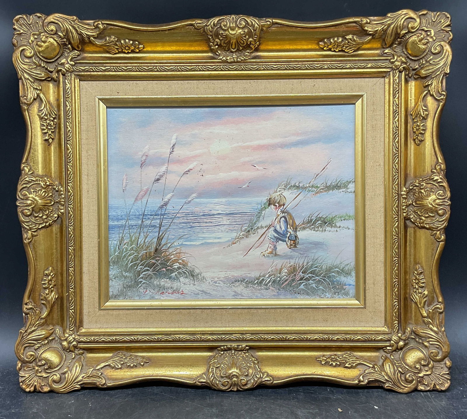 Signed Beach Fishing Scene Oil Painting: Framed oil on board painting. Signed at lower left illegibly. Beach scene with seated boy holding fishing pole. Ornate gilt wood frame. Not examined out of frame. Frame measures approx. 13.75 x 15.75