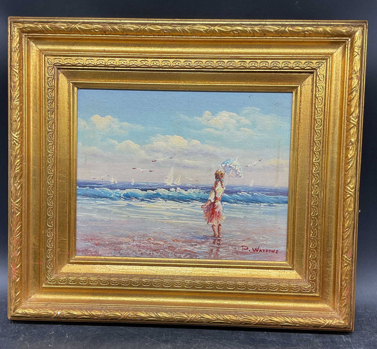 Signed P Watkins Beach Scene Girl Oil Painting: Framed oil on bod painting. Signed at lower right, P. Watkins. Possibly Peggy Watkins (American, b. 1963). Beach scene with girl holding parasol. Ornate gilt wood frame. Not examined out of frame. Fra