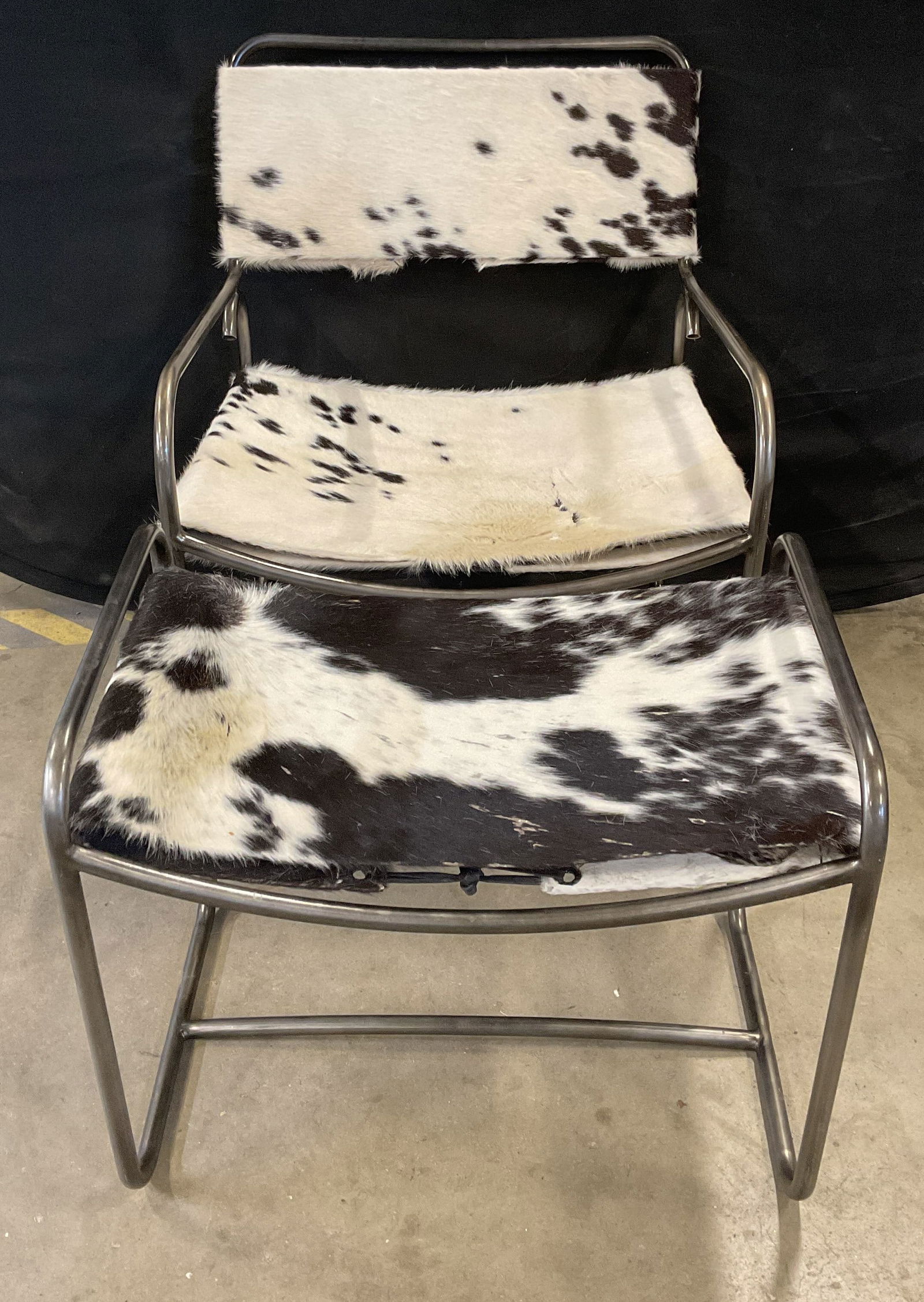 2 MCM Hair on Hide Armchair & Ottoman: Lot of 2 vintage mid century modern style matching silver tone metal frame armchair and ottoman with black and white hair on hide upholstery. Style of Le Corbusier, no signature or markings. Chair mea