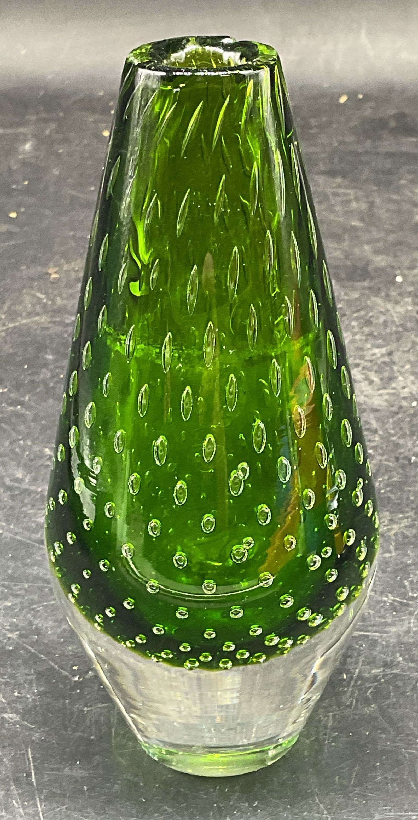 Green Controlled Bubble Art Glass Bud Vase: Hand blown art glass paperweight bud vase in green to clear with controlled bubble design. Measures approx. 2.5 x 5.5. Inches. Some scratching. Art glass vase, art glass paperweight, paperweight vase,