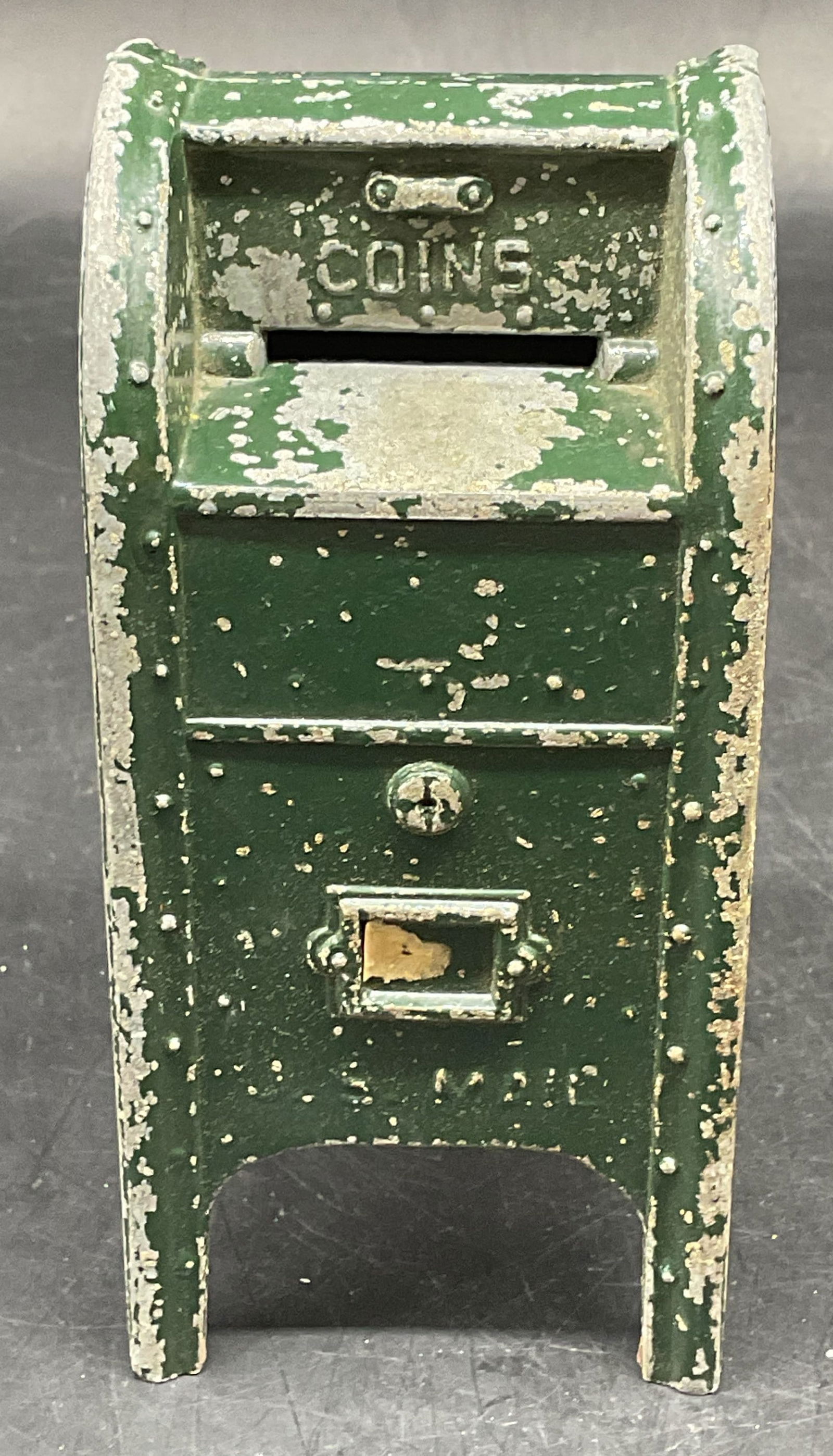 Vintage Green Enamel Metal Mailbox Coin Bank: Vintage green enameled metal postal mailbox motif coin bank. Measures approx. 2.5 x 2.5 x 5.5 inches. Wear including scratching, loss to enamel. Coin bank, vintage coin bank, mailbox coin bank, collec