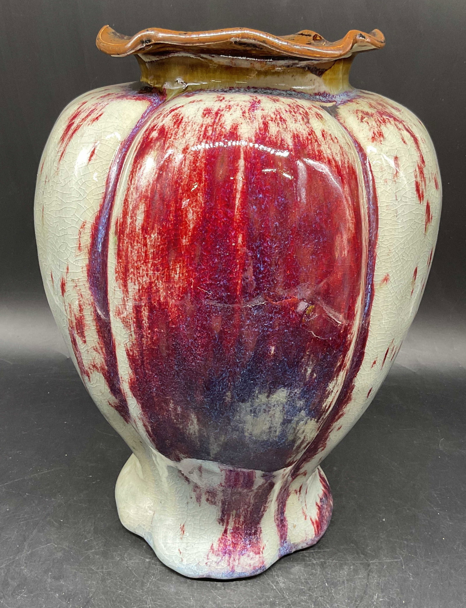 Antique Flambe Glazed Stoneware Vase: Antique art nouveau style Flambe glazed stoneware vase in green and red. Curved footed base with ruffled rim. Style of Ernest Chaplet, no signature or markings observed. Measures approx. 8 x 11 inches