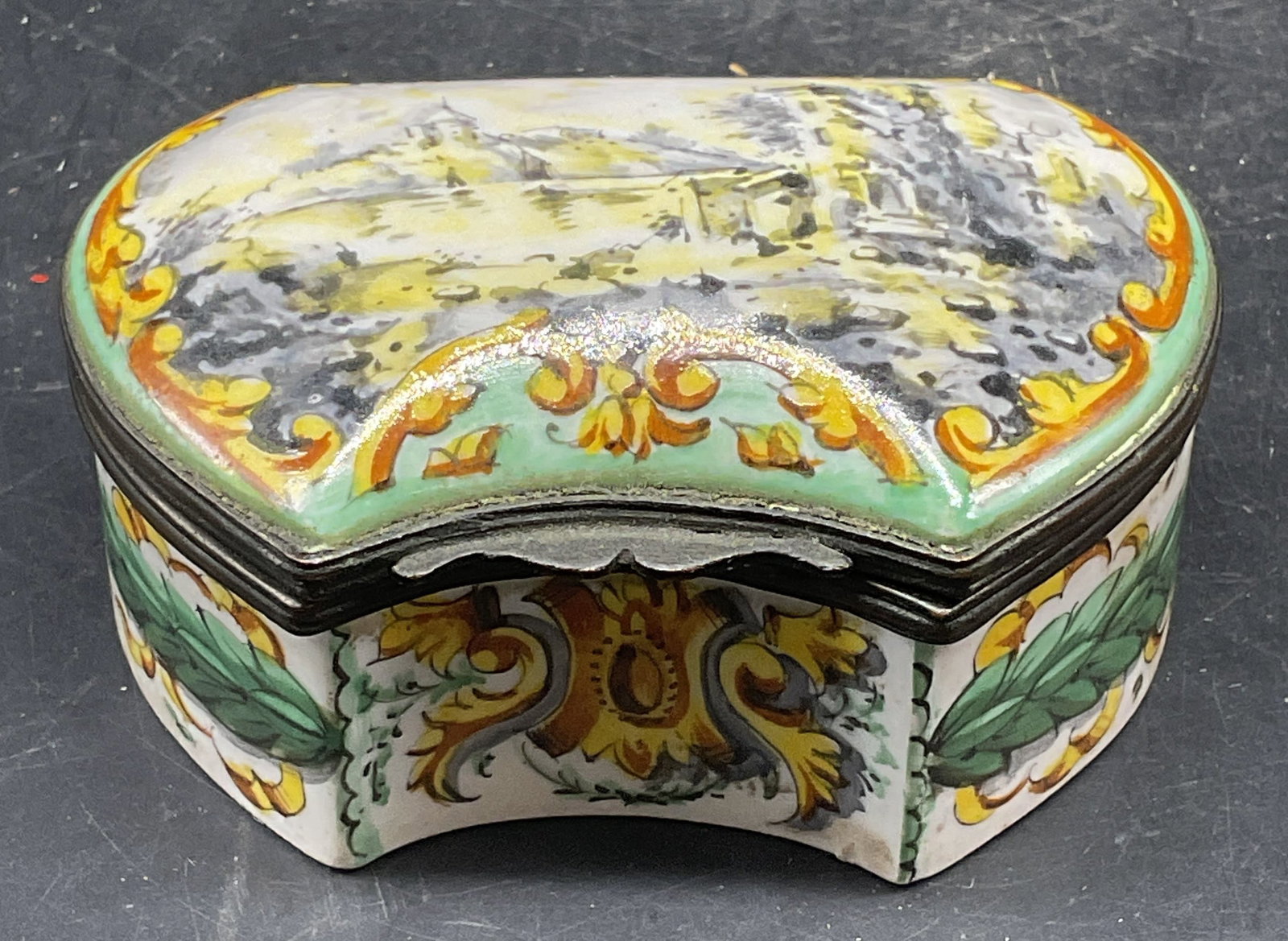 Vintage Porcelain Landscape Trinket Box: Vintage European style porcelain trinket box, hand painted landscape motif with ornate scroll designs. Measures approx. 3.25 x 2.25 x 1.5 inches. Some scratching and loss to paint. Porcelain trinket b