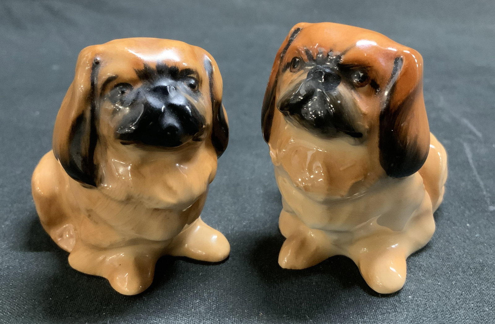 Pair Vtg Royal Doulton Pekingese Dog Figs ENGLAND: Lot includes, a pair of vintage Royal Doulton Pekingese dog figurines featuring a golden brown glaze. Bone china material. Signed & marked on underside. Reads, MADE IN ENGLAND ROYAL DOULTON BONE CHINA