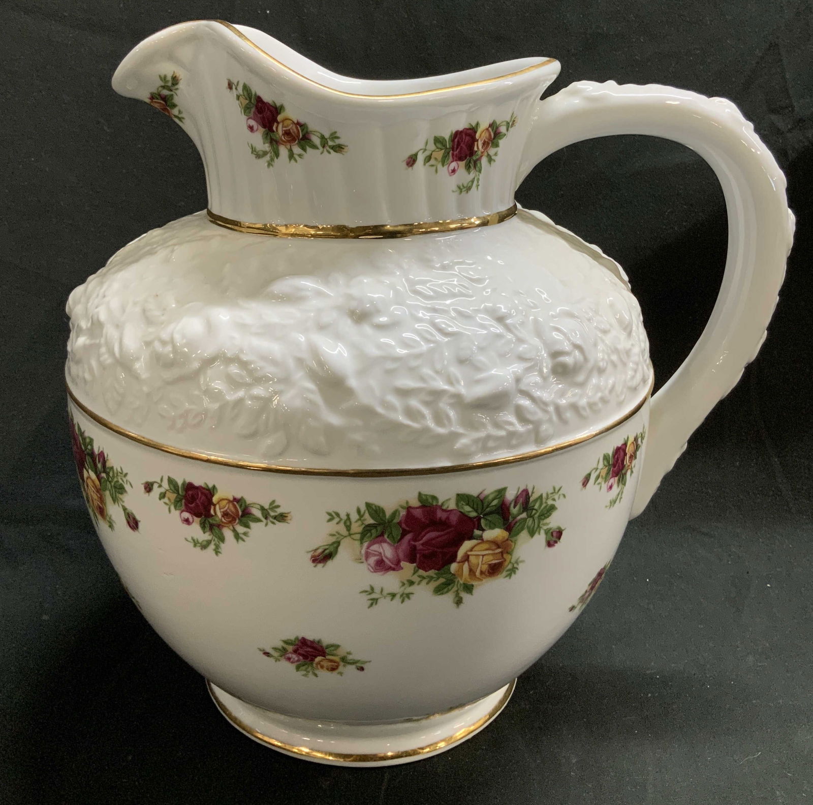 1962 Royal Albert Old Country Roses Pitcher: 1962 Royal Albert sculpted pitcher features an old country roses pattern on body. Vibrant floral motifs. Embossed floral detailing & gilt accents. Fine bone china. Signed & marked on underside. Reads,