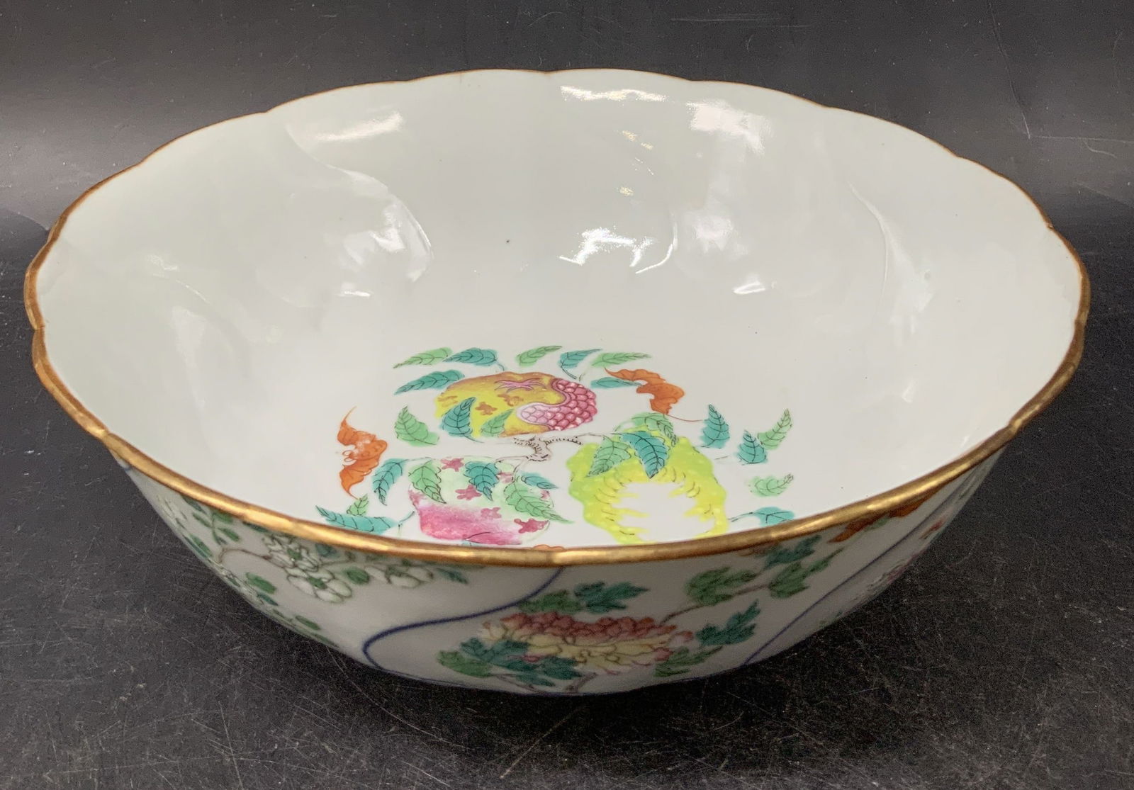 Sgnd Asian Hand Painted Floral Bowl: Asian porcelain bowl features hand painted floral/geometric motifs on exterior & interior with leaf accents. Scalloped rim. Signed & marked on underside. Visible Asian characters. Surface wear consist