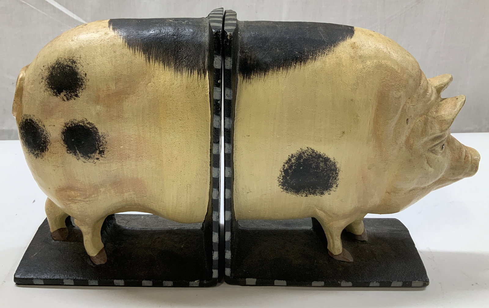Department 56 Cast Iron Pig Bookends: Department 56 cast iron pig bookends. Black & cream toned. Bookends have weight. Signed & marked. Reads, DEPARTMENT 56. Surface wear consistent to age, use & exposure. Measurements: length 7in x width