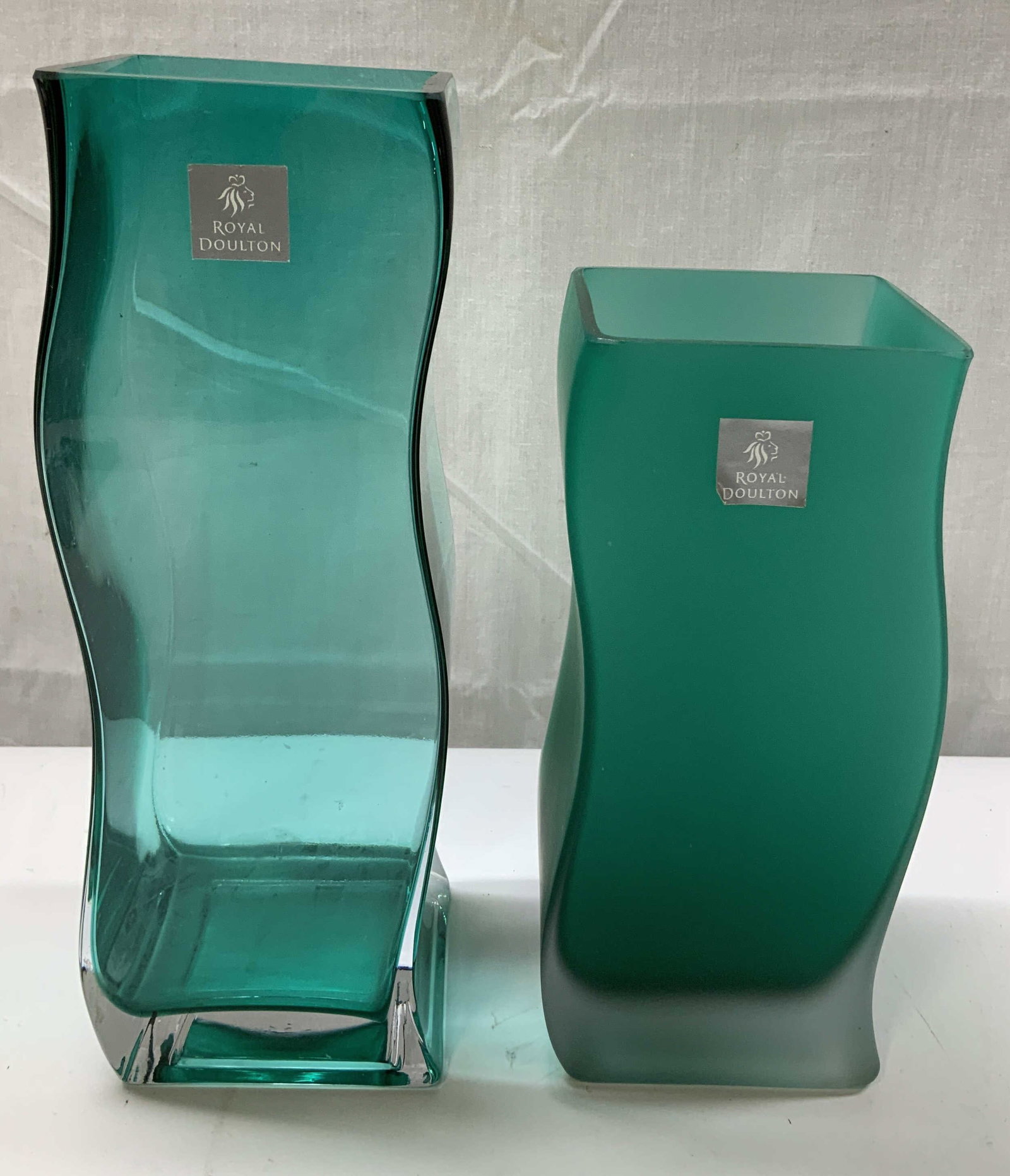 Lot 2 Royal Doulton Green Art Glass Vases: Lot includes, 2 Royal Doulton green art glass vases featuring a frosted & clear finish. Curved design. Signed & marked. Reads, ROYAL DOULTON. Surface wear consistent to age, use & exposure. Measuremen