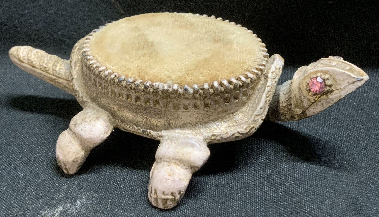 Vtg Florenzao Gilt Metal Turtle Pin Cushion: Vintage Florenzao gilt metal turtle pincushion features a nodding head & wagging tail. Faux rhinestone eyes. Velvet covered cushion on shell. Signed & marked. Reads, FLORENZAO. Surface wear