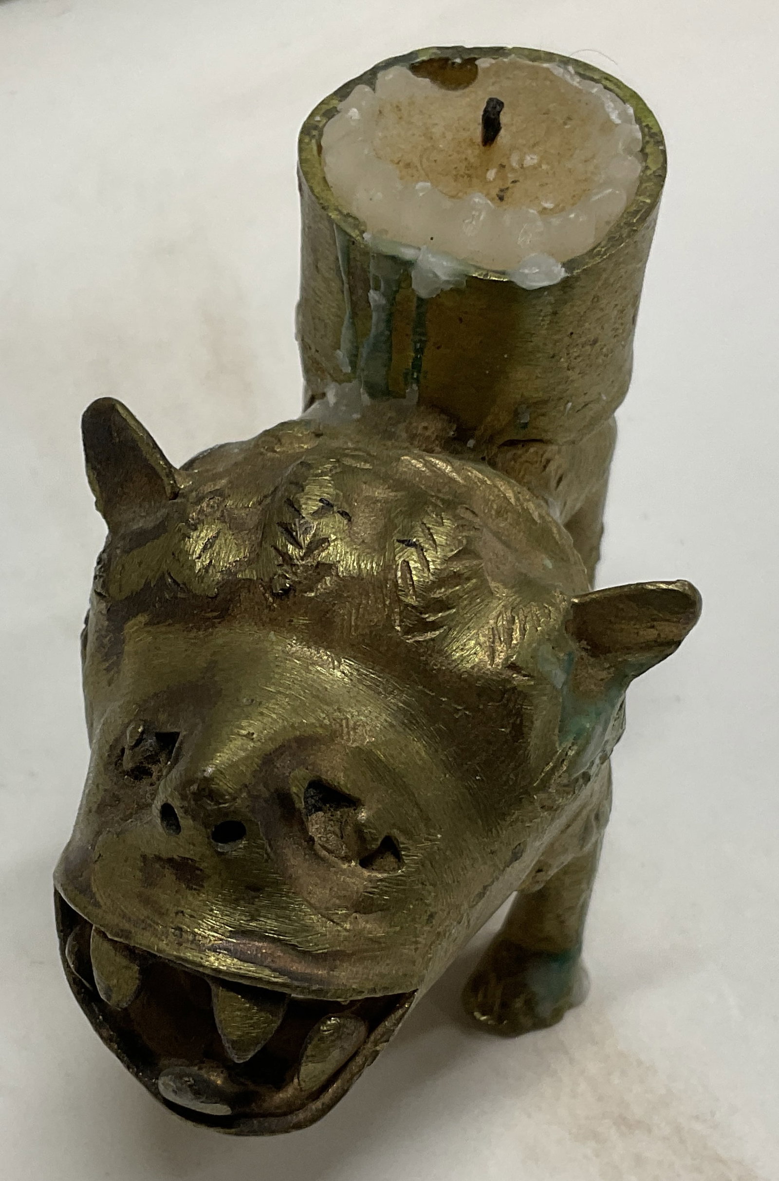 ATQ Brass Chinese Guardian Lion Candle Holder: Antique Brass Chinese Guardian Lion Candle Holder. Also referred to as a Foo Dog. Symbolizes protection and good fortune. Hollow at the bottom. Some aging consistent with exposure. Measures app