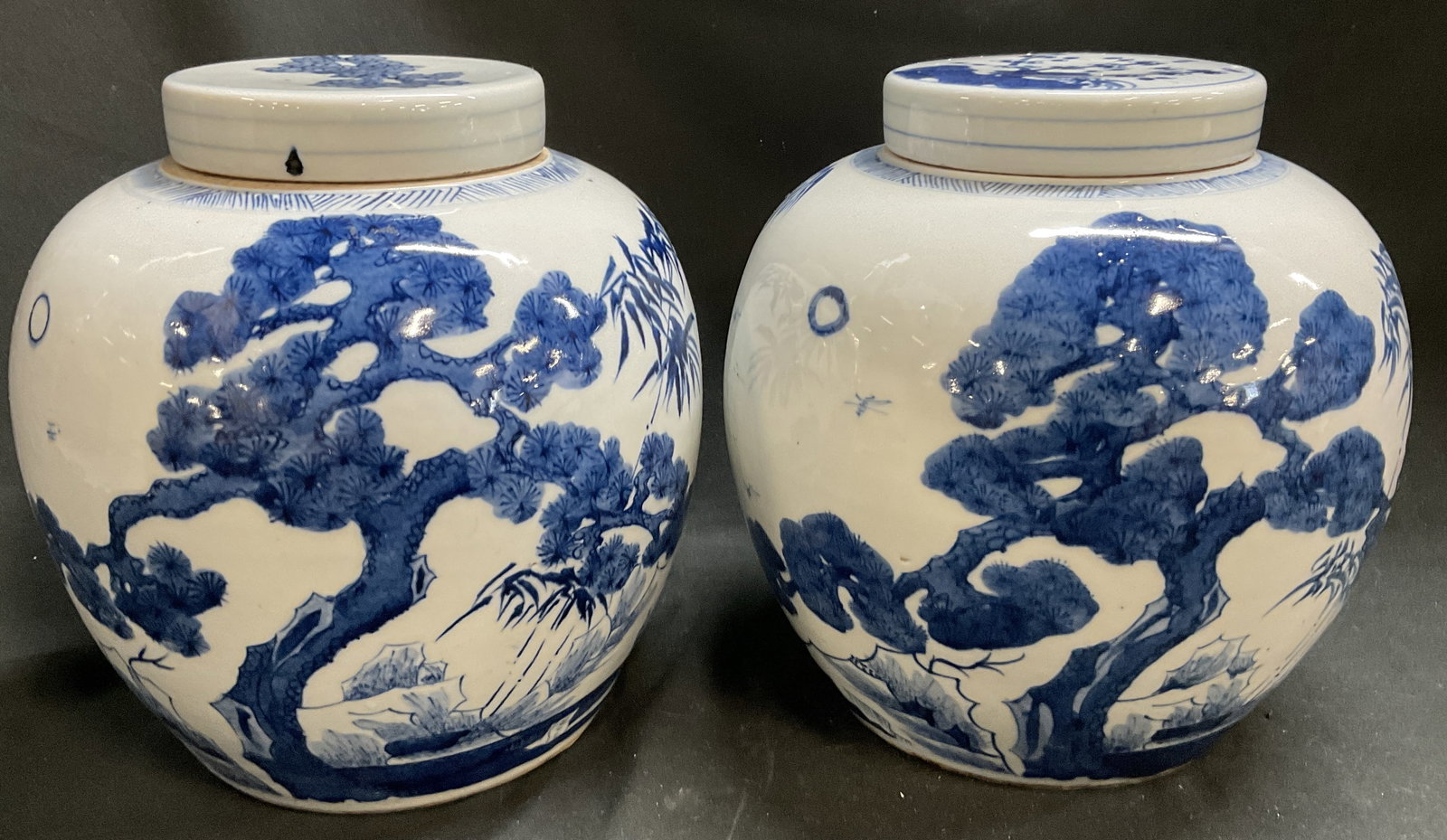 Pair ANTQ Asian Blue & White Porc Ginger Jars: Pair of 2 Antique Asian Blue & White Porcelain Ginger Jars. Matching Patterns. Different Florals on Lids. No visible signature. Features Three Friends of Winter Motif with pines, bamboo, and plum blos