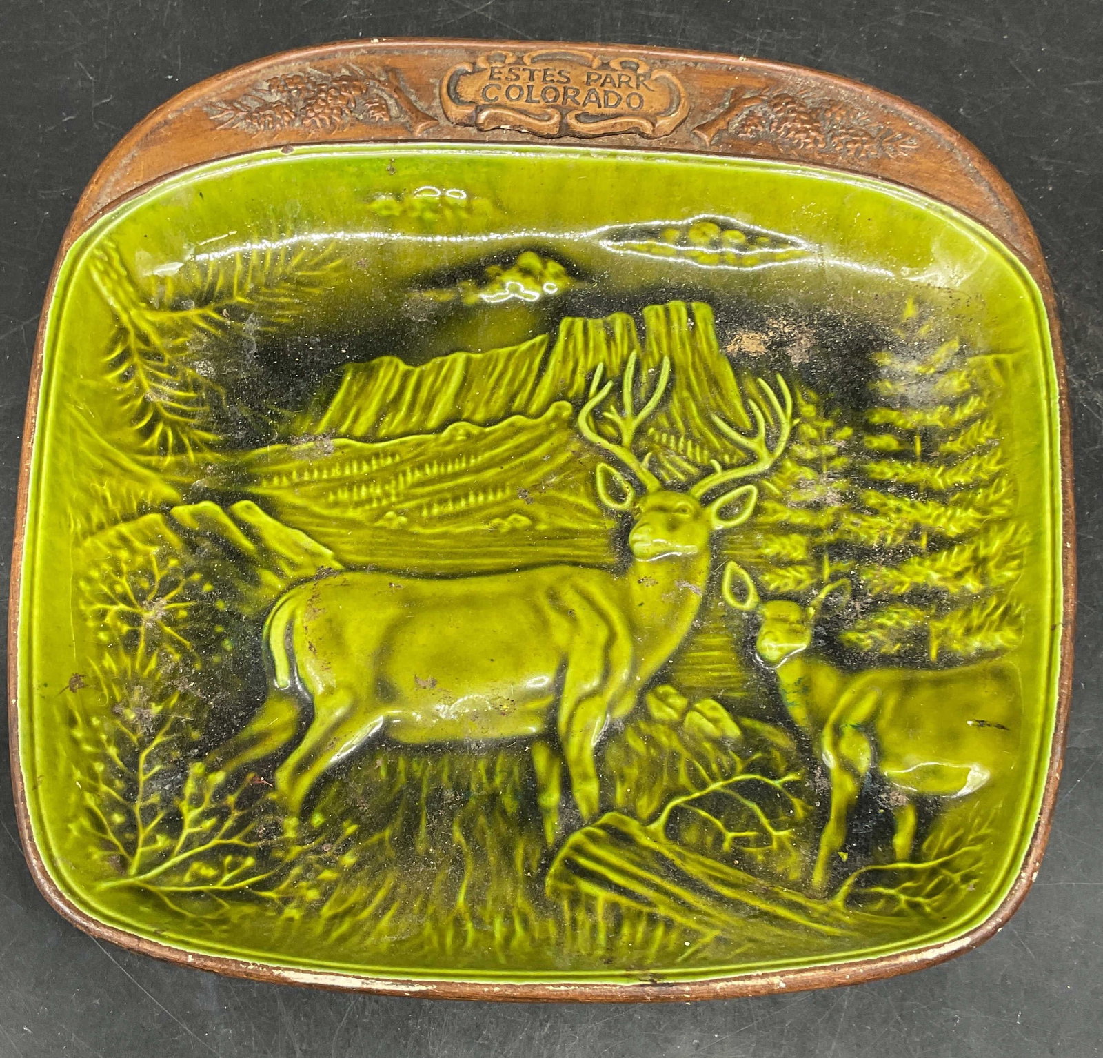 Treasure Craft Ceramic Buck Deer Dish USA: Vintage signed Treasure Craft ceramic souvenir dish. Estes Park, Colorado. Buck and fawn deer nature scene. Green and brown glaze. Measures approx. 9.5 x 9 x 1.5 inches. Made in USA. Some scratching a