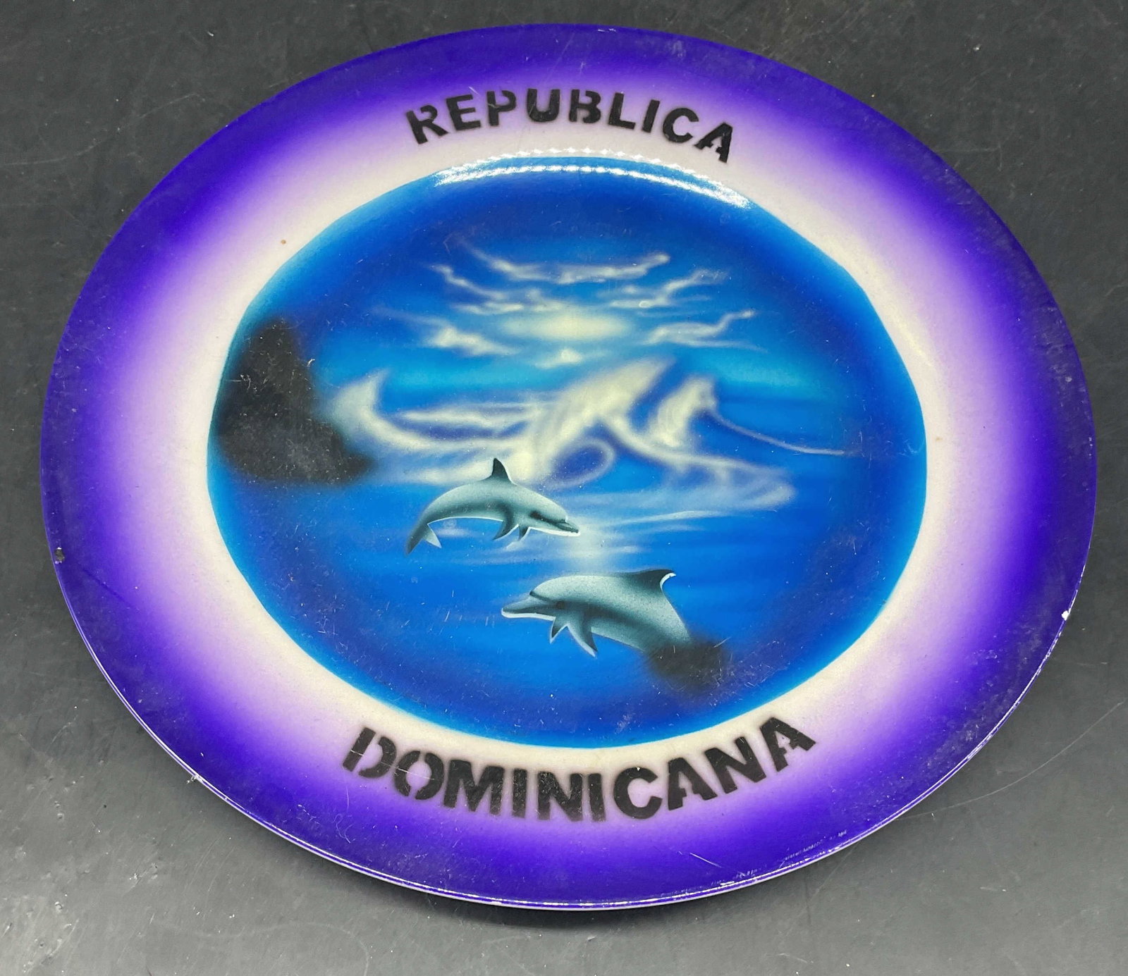 Dominican Republic Ceramic Souvenir Plate: Signed Dominican Republic ceramic souvenir plate, ocean and dolphins motif. Measures approx. 8 inches. Some scratching. Dominican Republic plate, souvenir plate, collectibles, home decor, home accesso