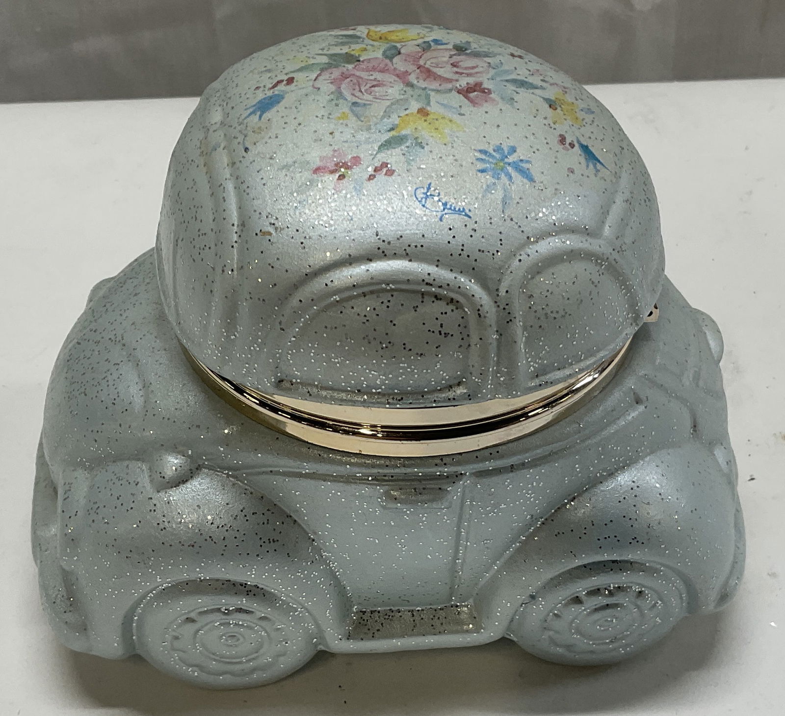 VTG Signed Creazioni Italy VW Beetle Box: VTG Signed Creazioni Italy VW Beetle Hinged Trinket Box. Blue ceramic with glitter and painted floral pattern. Signature on hood reads illegibly. Measures app 4in H x 3in diameter. Condition consisten